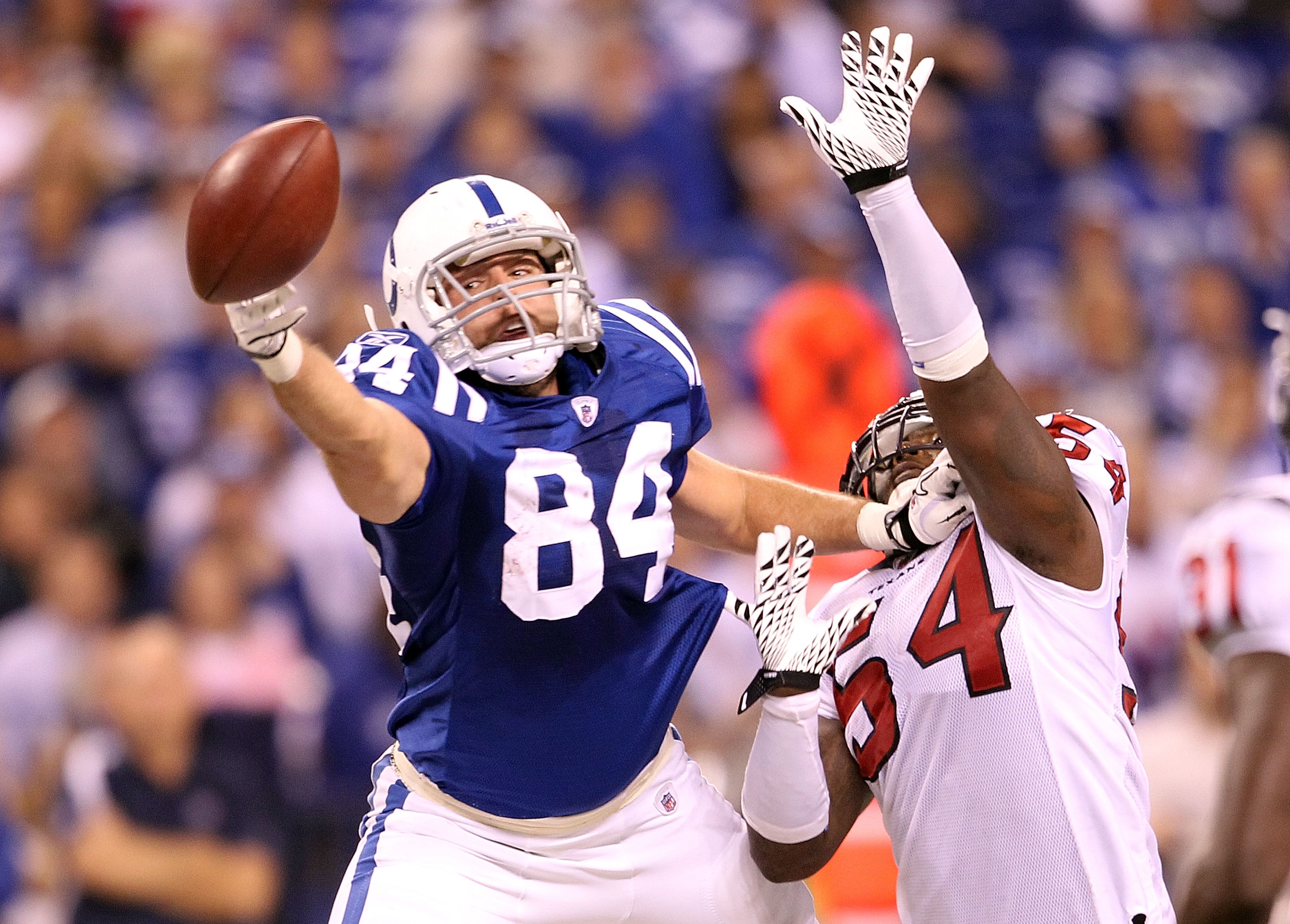 INDIANAPOLIS - NOVEMBER 01:  Jacob Tamme #84 of Indianapolis Colts reaches out to grab a pass while defended by Zac Diles #54 of the Houston Texans  during the NFL game at Lucas Oil Stadium on November 1, 2010 in Indianapolis, Indiana.  (Photo by Andy Lyo