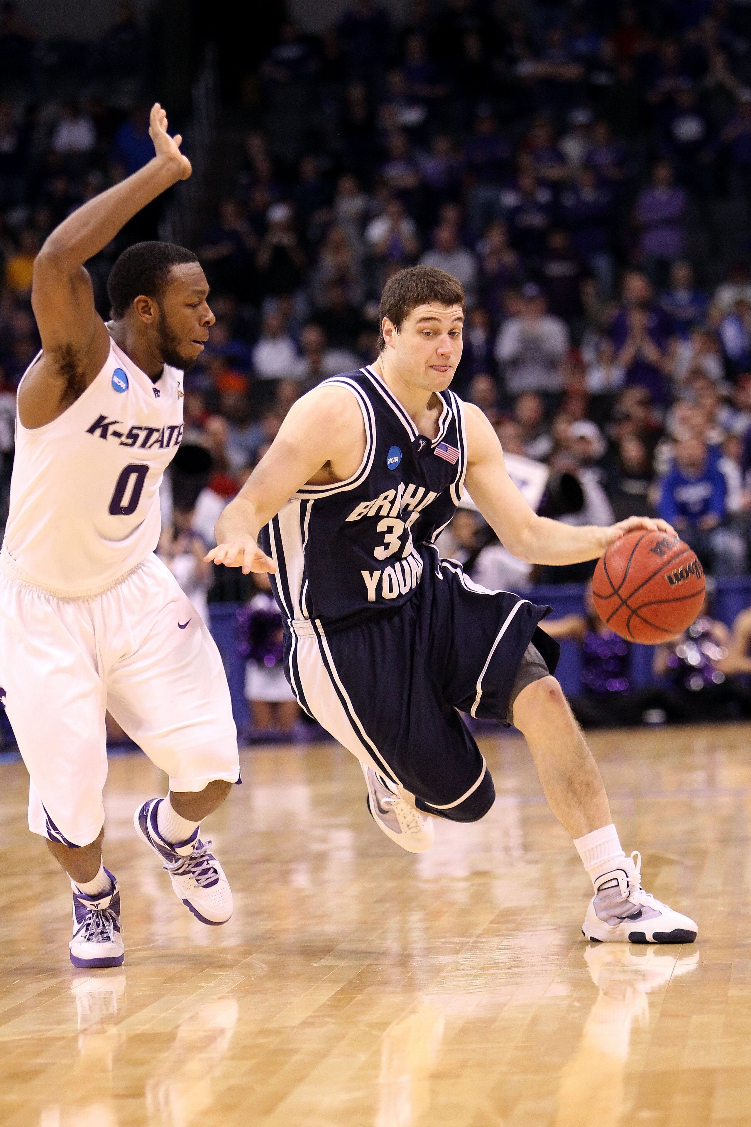 OKLAHOMA CITY - MARCH 20:  Jimmer Fredette #32 of the Brigham Young Cougars drives against Jacob Pullen #0 of the Kansas State Wildcats during the second round of the 2010 NCAA men's basketball tournament at Ford Center on March 20, 2010 in Oklahoma City,
