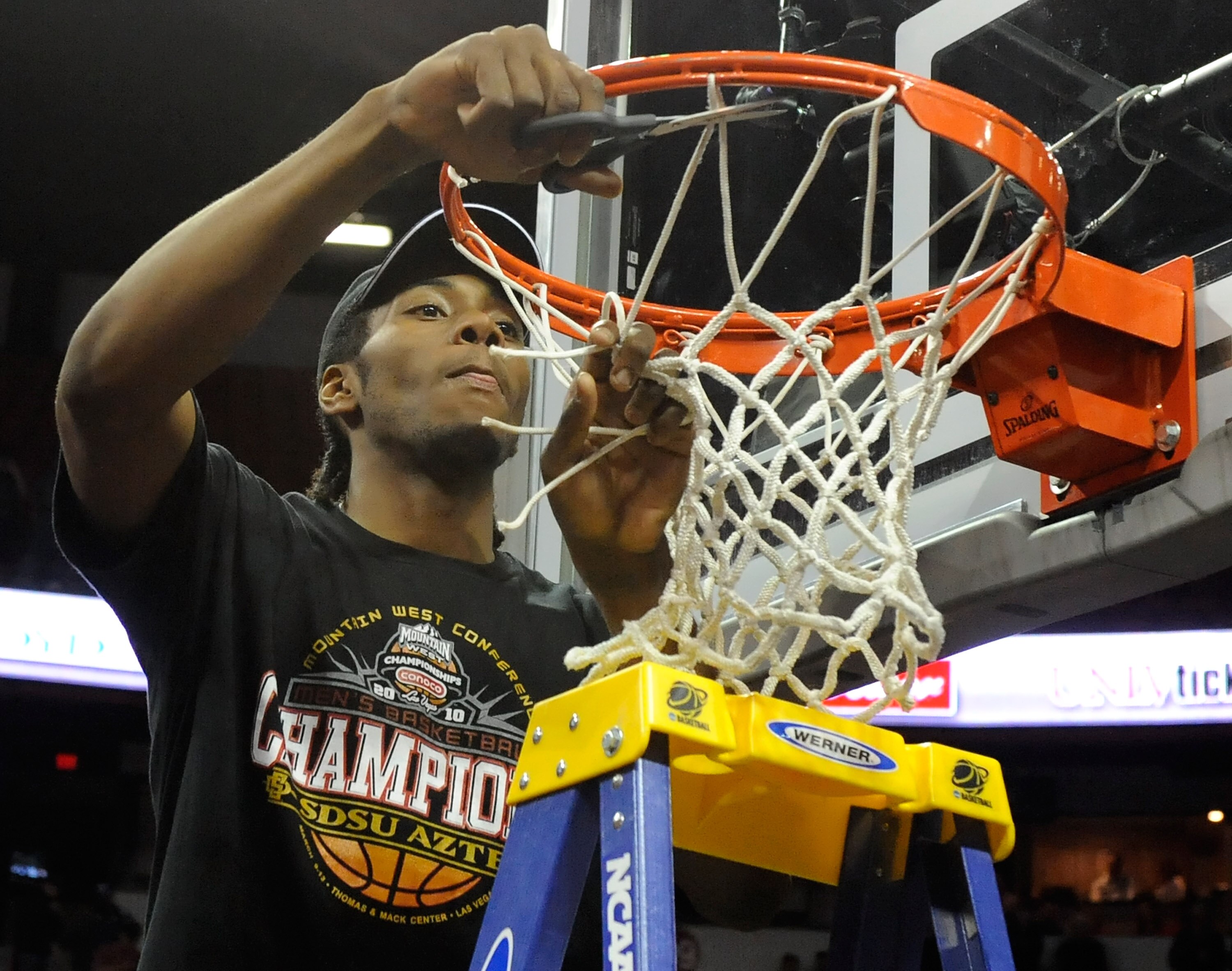 LAS VEGAS - MARCH 13:  Kawhi Leonard #15 of the San Diego State Aztecs cuts down the net after defeating the UNLV Rebels 55-45 in the championship game of the Conoco Mountain West Conference Basketball tournament at the Thomas & Mack Center March 13, 2010