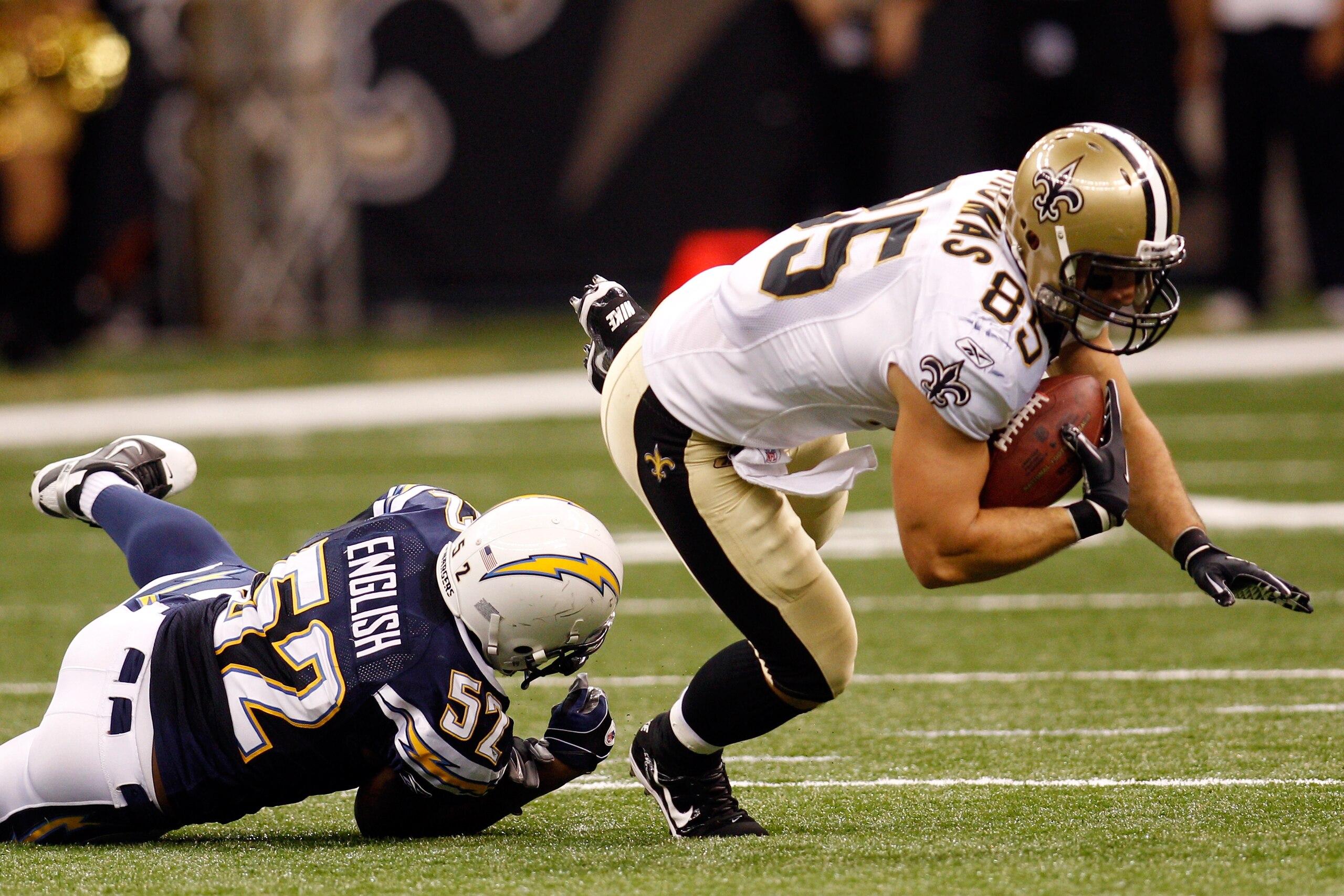 NEW ORLEANS - AUGUST 27:  Larry English #52 of the San Diego Chargers tackles David Thomas #85 of the New Orleans Saints at the Louisiana Superdome on August 27, 2010 in New Orleans, Louisiana.  (Photo by Chris Graythen/Getty Images)