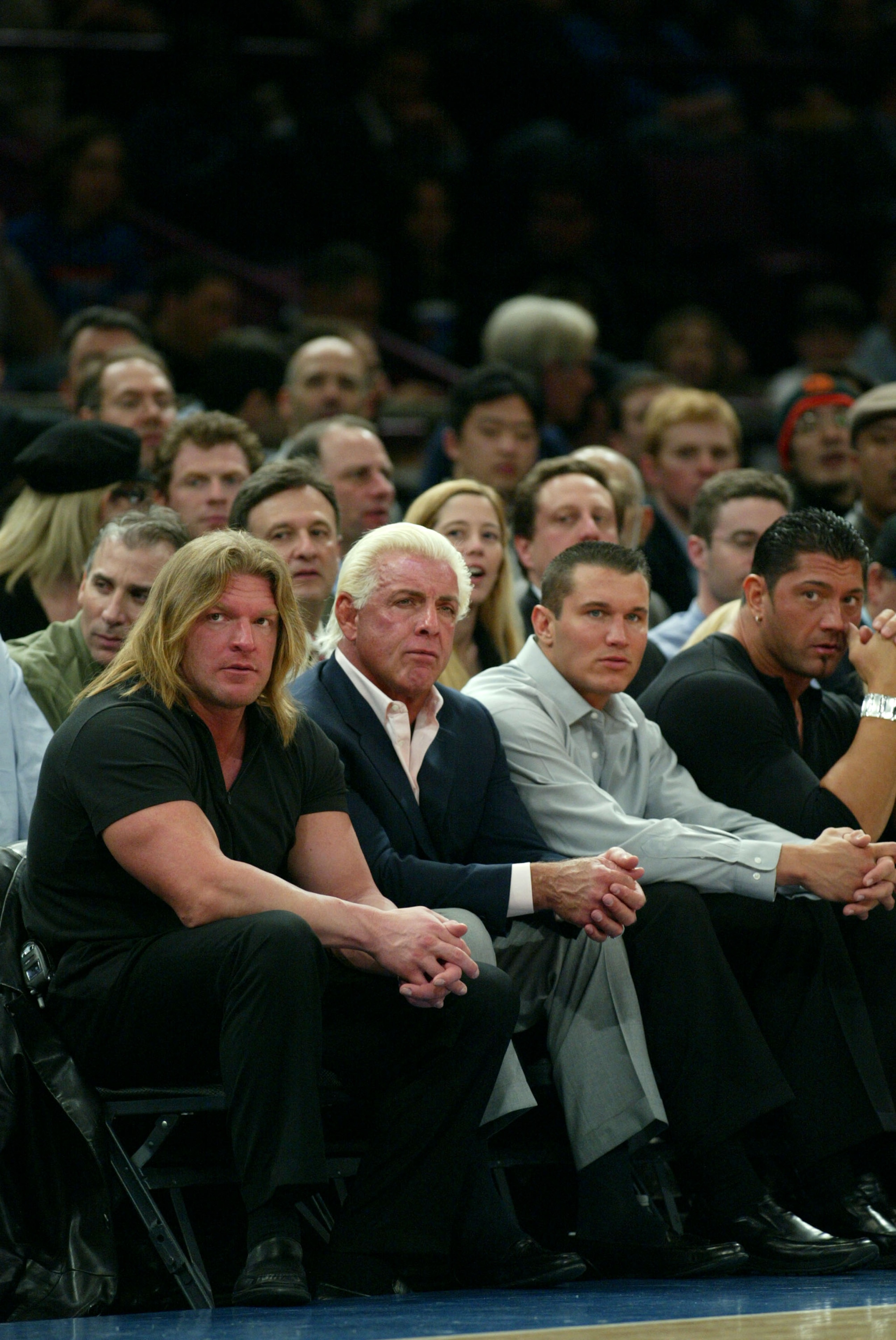 NEW YORK - MARCH 9:  WWE wrestlers (L-R) Triple H, Ric Flair, Randy Orton and Batista sit courtside at the New York Knicks v Boston Celtics  NBA game March 9, 2004 at Madison Square Garden in New York City.   (Photo by Ray Amati/Getty Images)