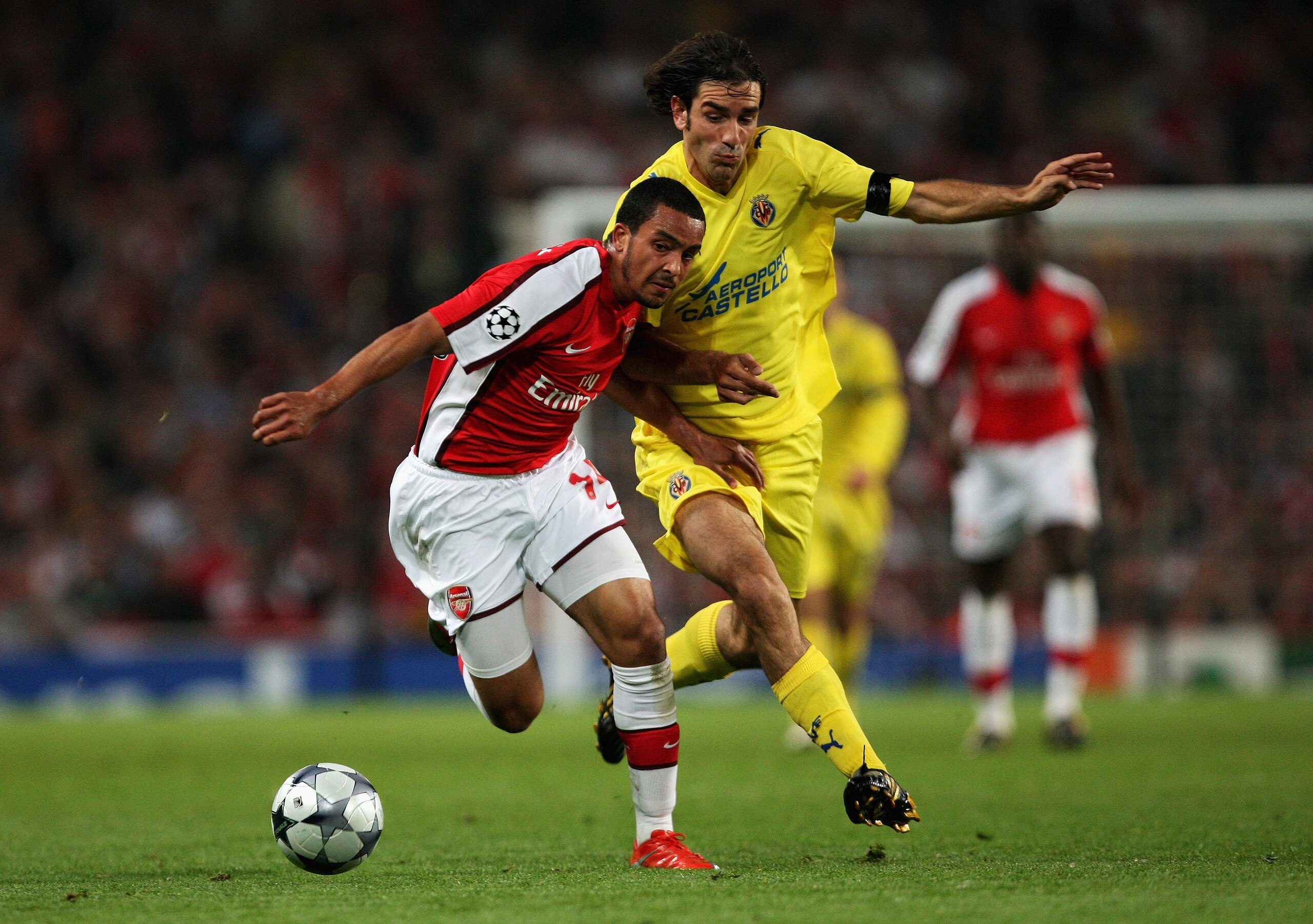 LONDON, ENGLAND - APRIL 15:  Theo Walcott of Arsenal battles for the ball with Robert Pires of Villarreal during the UEFA Champions League Quarter Final Second Leg match between Arsenal and Villarreal at the Emirates Stadium on April 15, 2009 in London, E