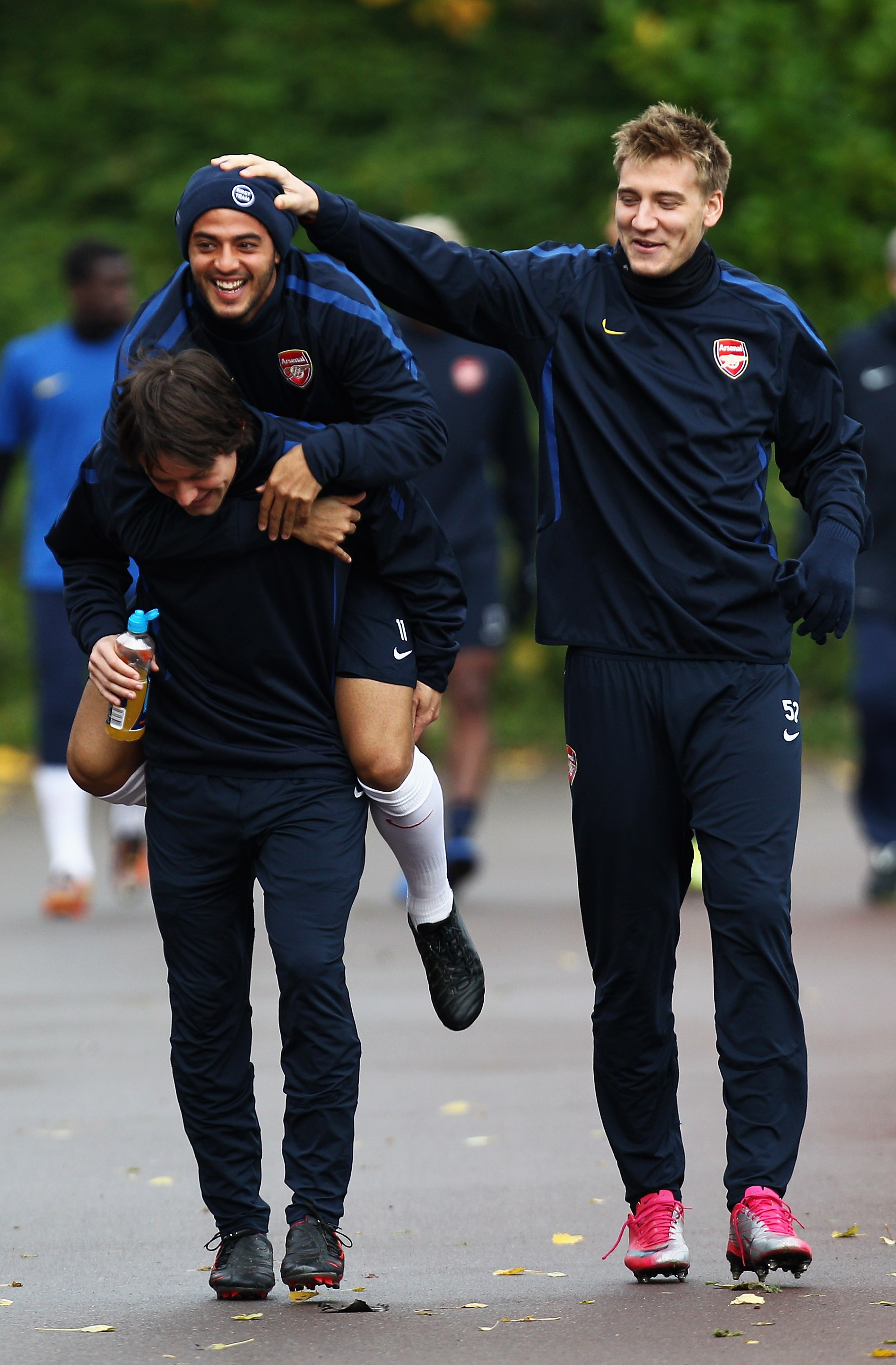ST ALBANS, ENGLAND - NOVEMBER 02: Carlos Alberto Vela jumps on the back of team mate Tomas Rosicky as Nicklas Bendtner (R) laughs during a training session ahead of the UEFA Champions League Group H match against Shakhtar Donetsk at the club's complex at ST ALBANS, ENGLAND - NOVEMBER 02: Carlos Alberto Vela jumps on the back of team mate Tomas Rosicky as Nicklas Bendtner (R) laughs during a training session ahead of the UEFA Champions League Group H match against Shakhtar Donetsk at the club's complex at