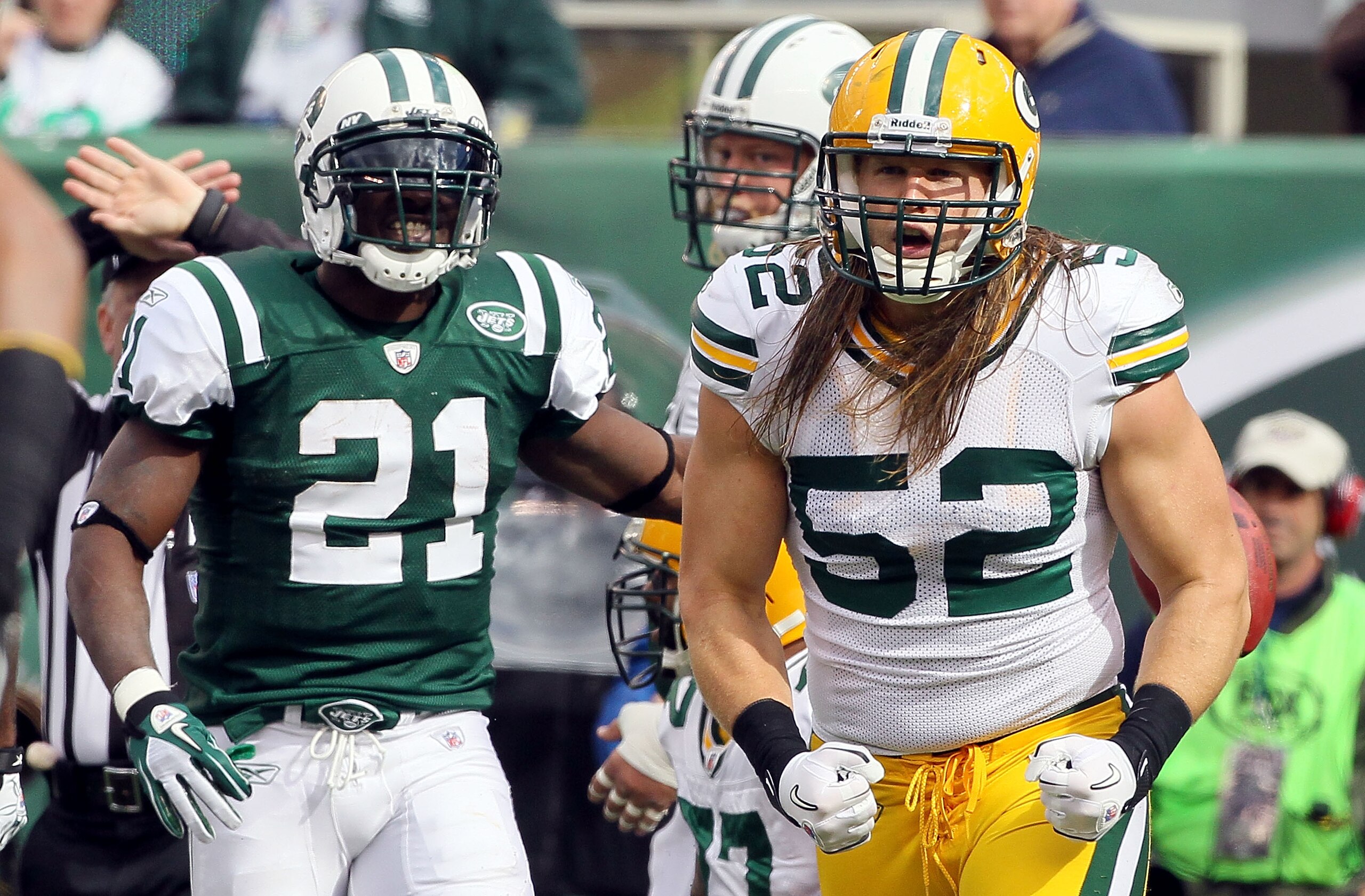 EAST RUTHERFORD, NJ - OCTOBER 31:  Clay Matthews #52 of the Green Bay Packers celebrates a play as LaDainian Tomlinson #21 of the New York Jets looks on on October 31, 2010 at the New Meadowlands Stadium in East Rutherford, New Jersey.  (Photo by Jim McIs