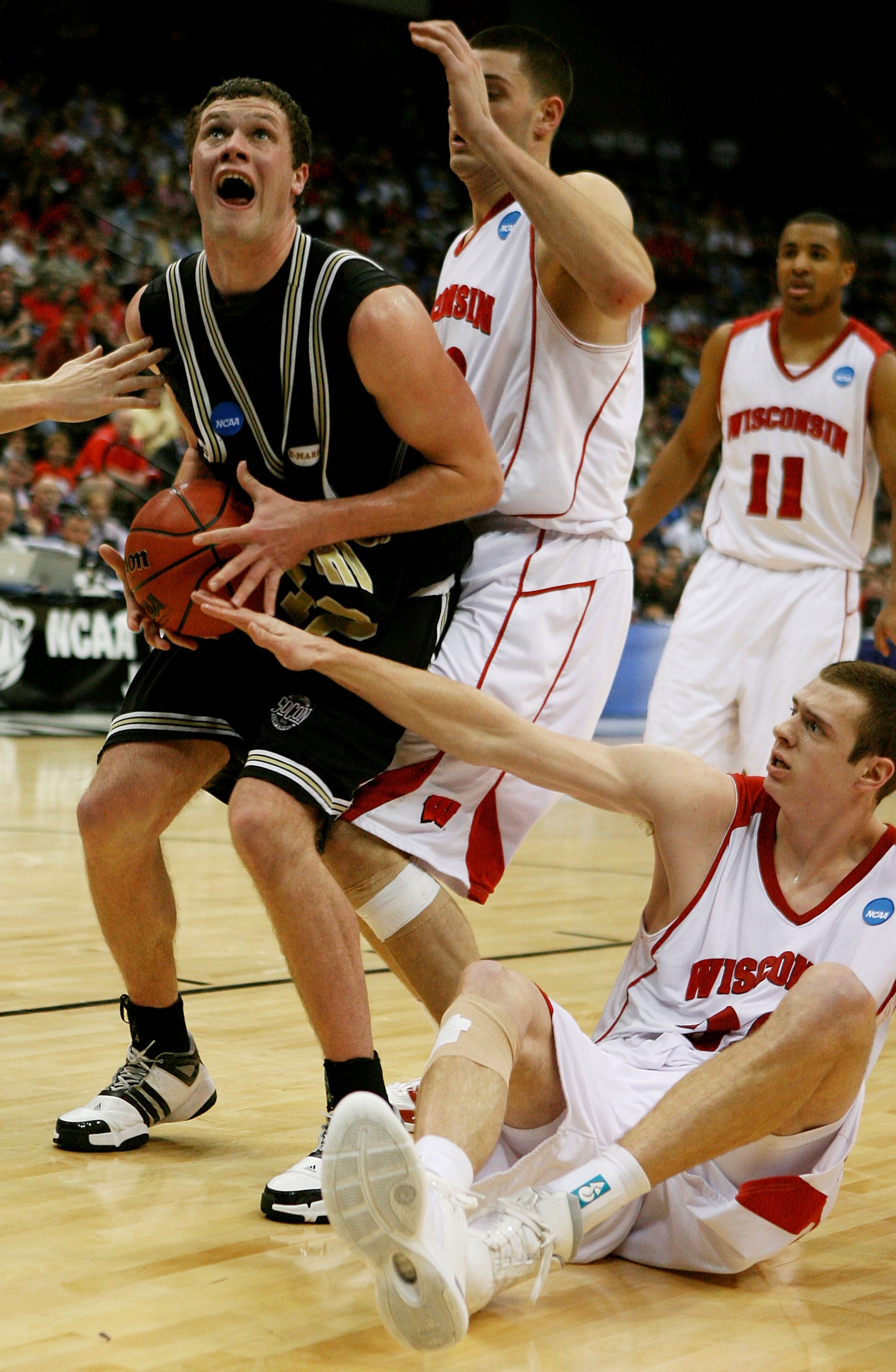 JACKSONVILLE, FL - MARCH 19:  Noah Dahlman #42 of the Wofford Terriers grabs a rebound between Keaton Nankivil #52 and Jon Leuer #30 of the Wisconsin Badgers during the first round of the 2010 NCAA men's basketball tournament at Jacksonville Veteran's Mem