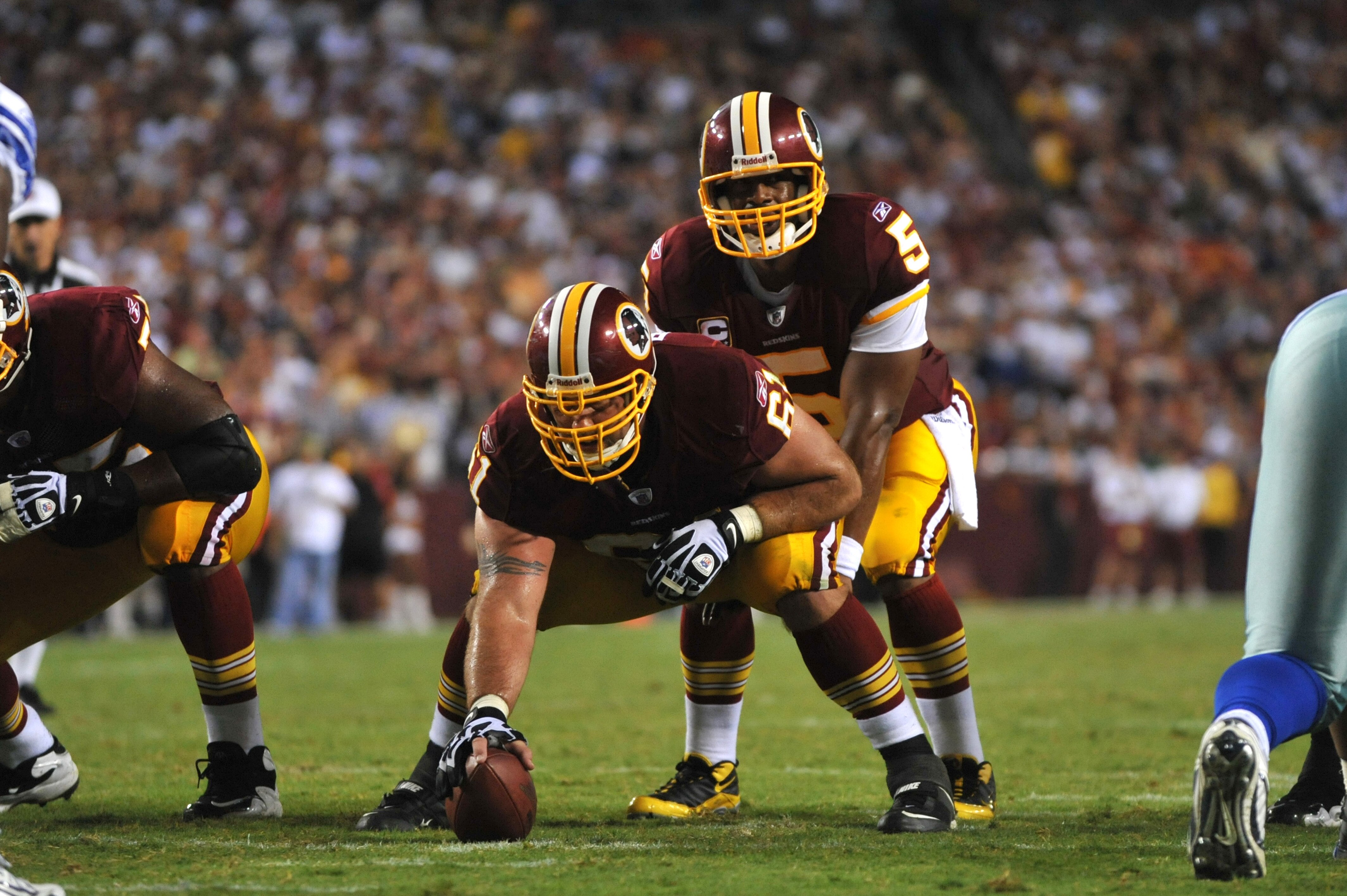 LANDOVER - SEPTEMBER 12:  Casey Rabach #61 of the Washington Redskins prepares to snap the ball during the NFL season opener against the Dallas Cowboys at FedExField on September 12, 2010 in Landover, Maryland. The Redskins defeated the Cowboys 13-7. (Pho