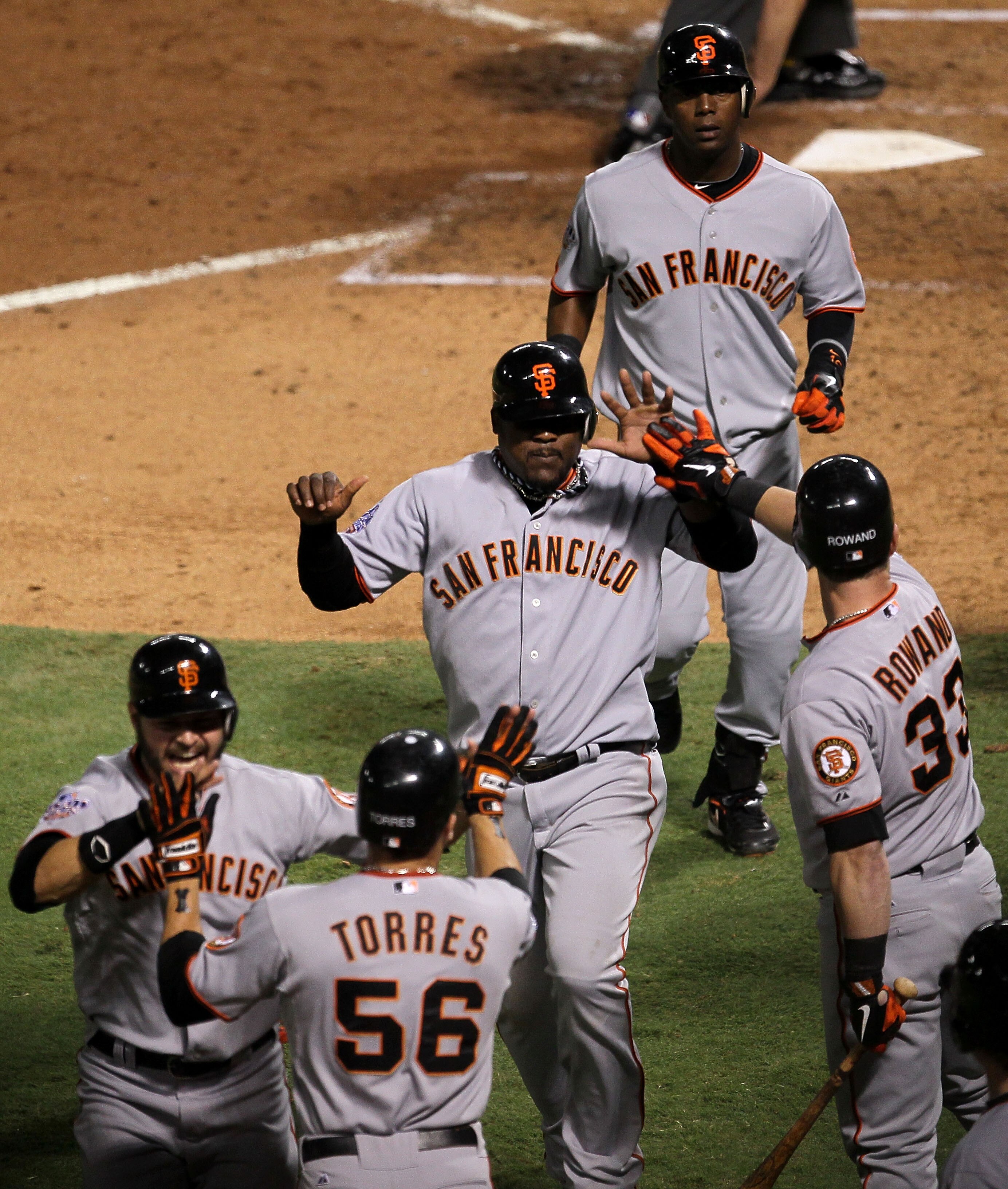 ARLINGTON, TX - NOVEMBER 01:   Cody Ross #13, Edgar Renteria #16, Juan Uribe #5, Andres Torres #56 and Aaron Rowand #33 of the San Francisco Giants celebrate after they scored on a 3-run home run hit by Renteria #16 in the seventh inning against the Texas