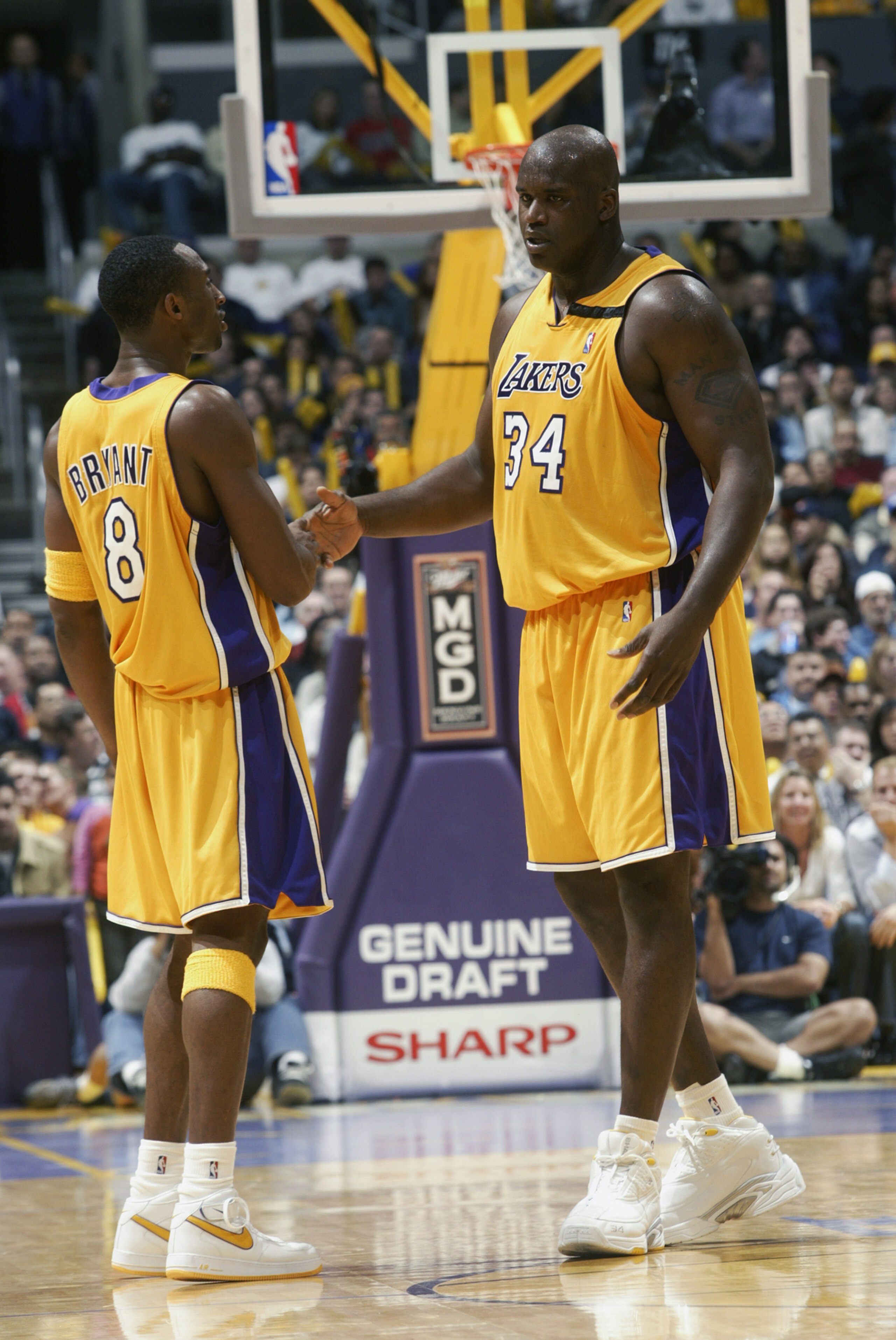 LOS ANGELES - NOVEMBER 22: Kobe Bryant #8 and Shaquille O'Neal #34 of the Los Angeles Lakers congratulate each other during the NBA game against the Chicago Bulls at Staples Center on November 22, 2002 in Los Angeles, California. The Lakers won 86-73. LOS ANGELES - NOVEMBER 22: Kobe Bryant #8 and Shaquille O'Neal #34 of the Los Angeles Lakers congratulate each other during the NBA game against the Chicago Bulls at Staples Center on November 22, 2002 in Los Angeles, California. The Lakers won 86-73.