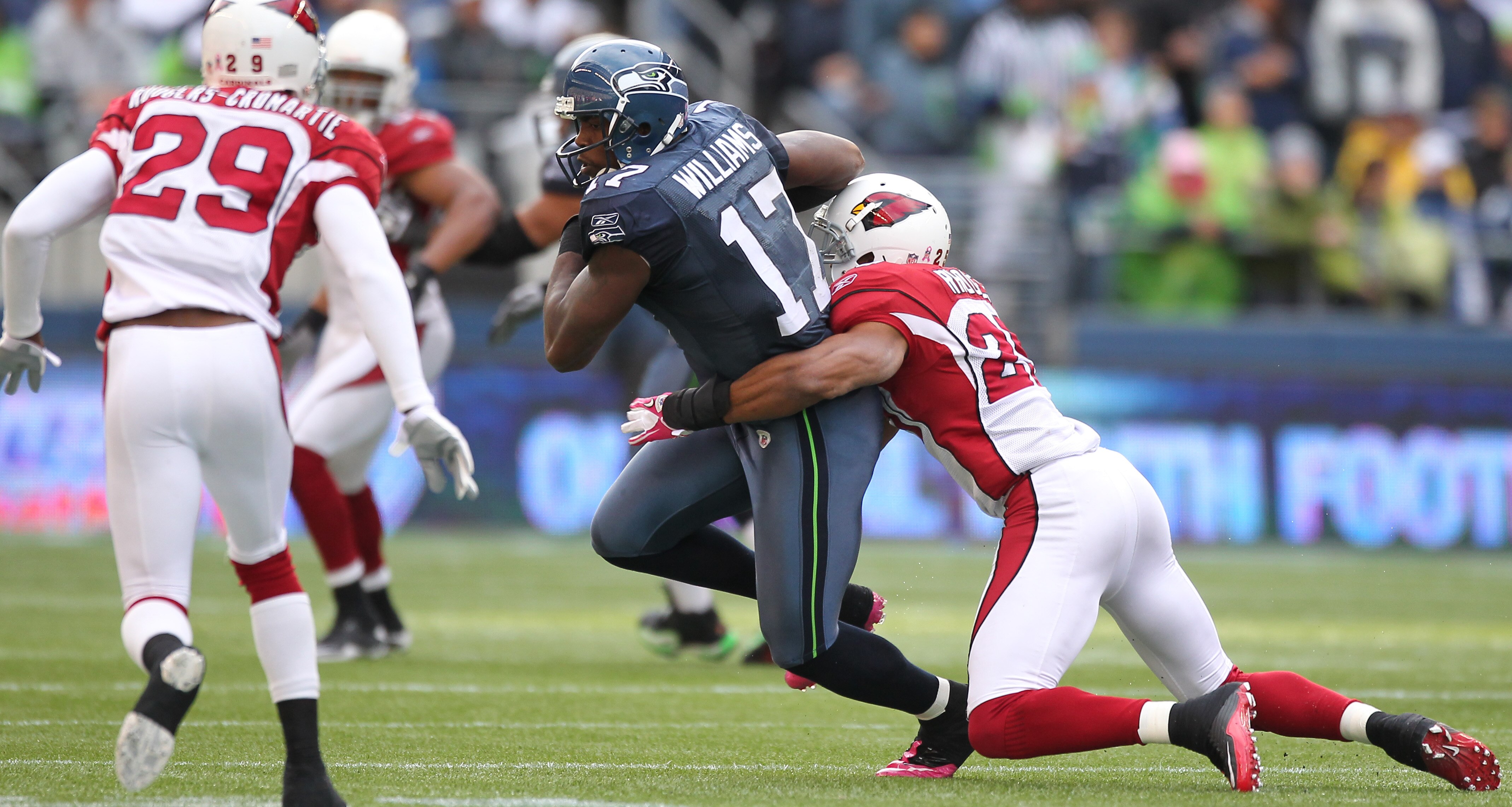 SEATTLE - OCTOBER 24:  Wide receiver Mike Williams #17 of the Seattle Seahawks is tackled by Kerry Rhodes #25 of the Arizona Cardinals at Qwest Field on October 24, 2010 in Seattle, Washington. (Photo by Otto Greule Jr/Getty Images)