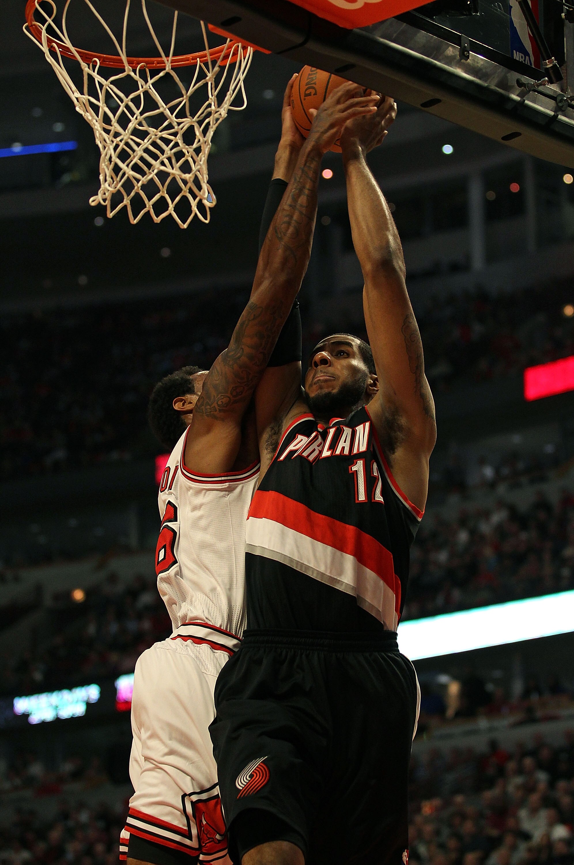 CHICAGO - NOVEMBER 01: LaMarcus Aldridge #12 of the Portland Trail Blazers is fouled while shooting by James Johnson #16 of the Chicago Bulls at the United Center on November 1, 2010 in Chicago, Illinois. The Bulls defeated the Trail Blazers 110-98. NOTE