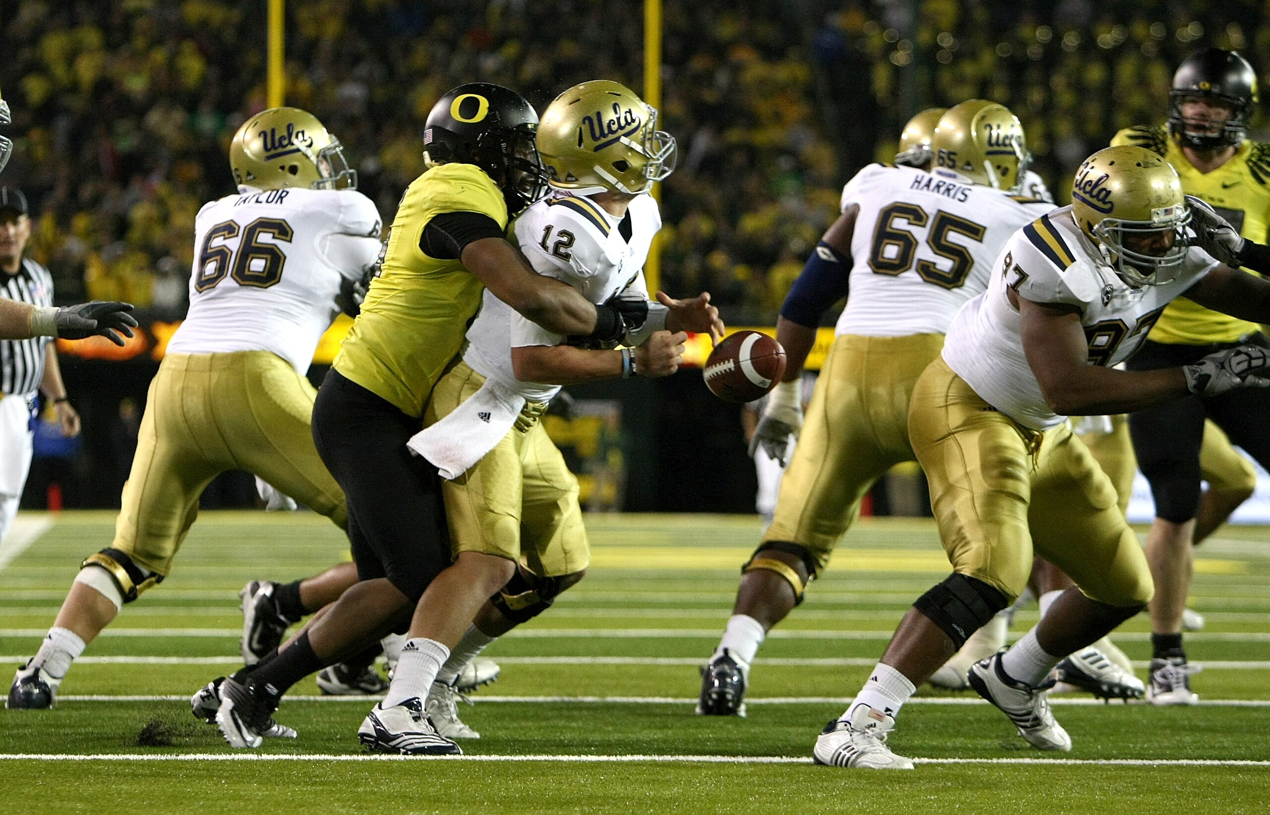 EUGENE, OR - OCTOBER 21: Richard Brehaut #12 of the UCLA Bruins is sacked by Kenny Rowe #58 of the Oregon Ducks causing a fumble on October 21, 2010 at the Autzen Stadium in Eugene, Oregon. (Photo by Jonathan Ferrey/Getty Images) EUGENE, OR - OCTOBER 21: Richard Brehaut #12 of the UCLA Bruins is sacked by Kenny Rowe #58 of the Oregon Ducks causing a fumble on October 21, 2010 at the Autzen Stadium in Eugene, Oregon. (Photo by Jonathan Ferrey/Getty Images)
