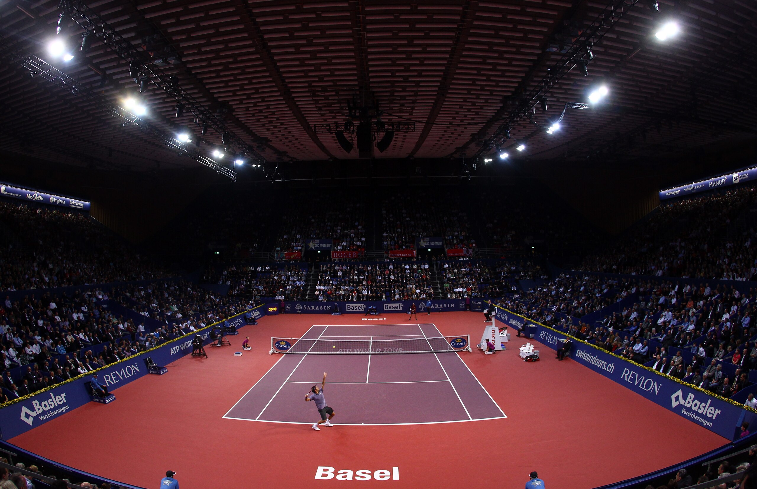 BASEL, SWITZERLAND - NOVEMBER 03:  A general view of Roger Federer of Switzerland serving to Janko Tipsarevic of Serbia during Day Three of the Davidoff Swiss Indoors Tennis at St Jakobshalle on November 3, 2010 in Basel, Switzerland.  (Photo by Julian Fi