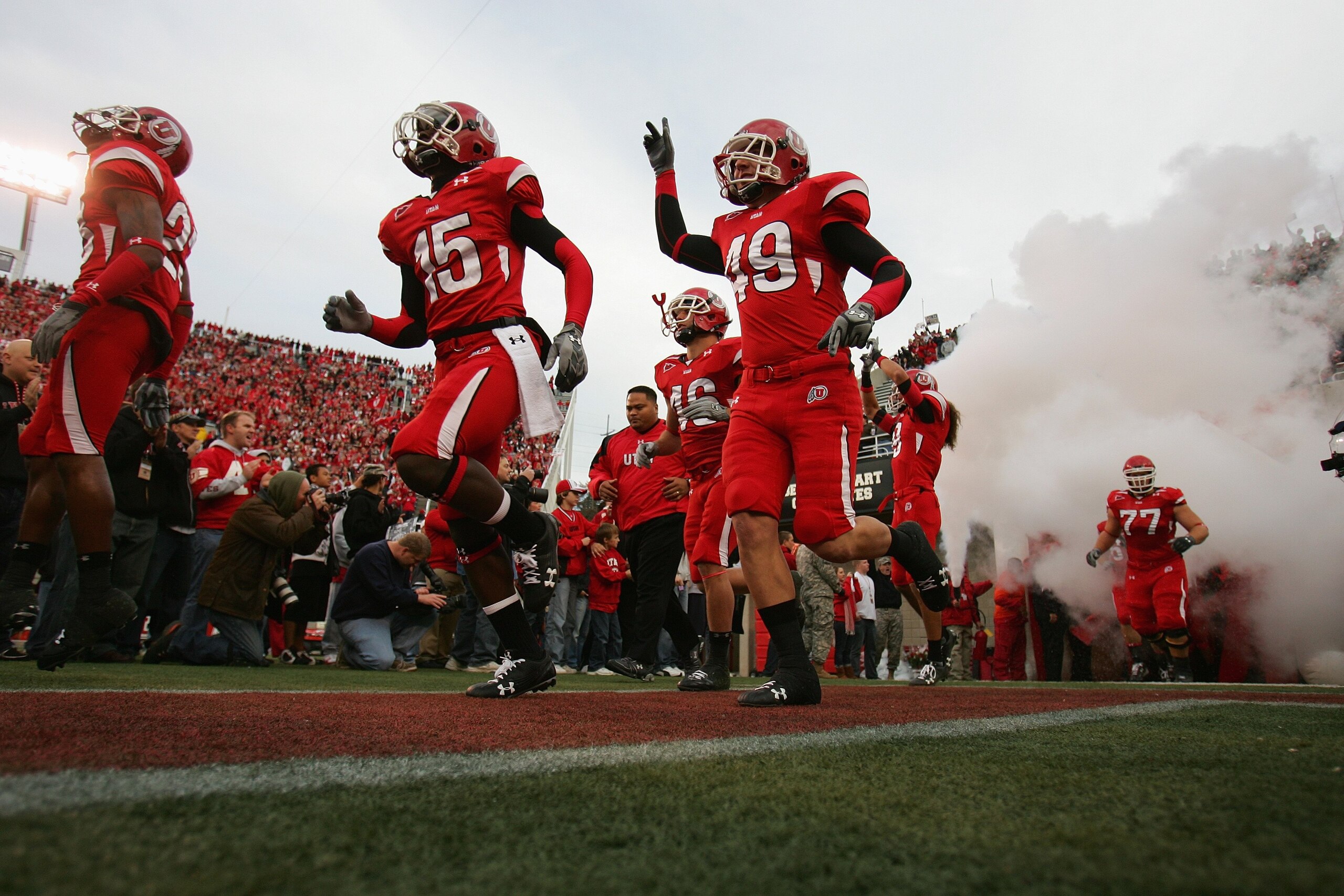 SALT LAKE CITY, UT - NOVEMBER 22:  DeVonte Christopher #15 and Greg Bird #49 of the Utah Utes run onto the field before the game against the BYU Cougars at Rice-Eccles Stadium on November 22, 2008 in Salt Lake City, Utah. (Photo by Jonathan Ferrey/Getty I