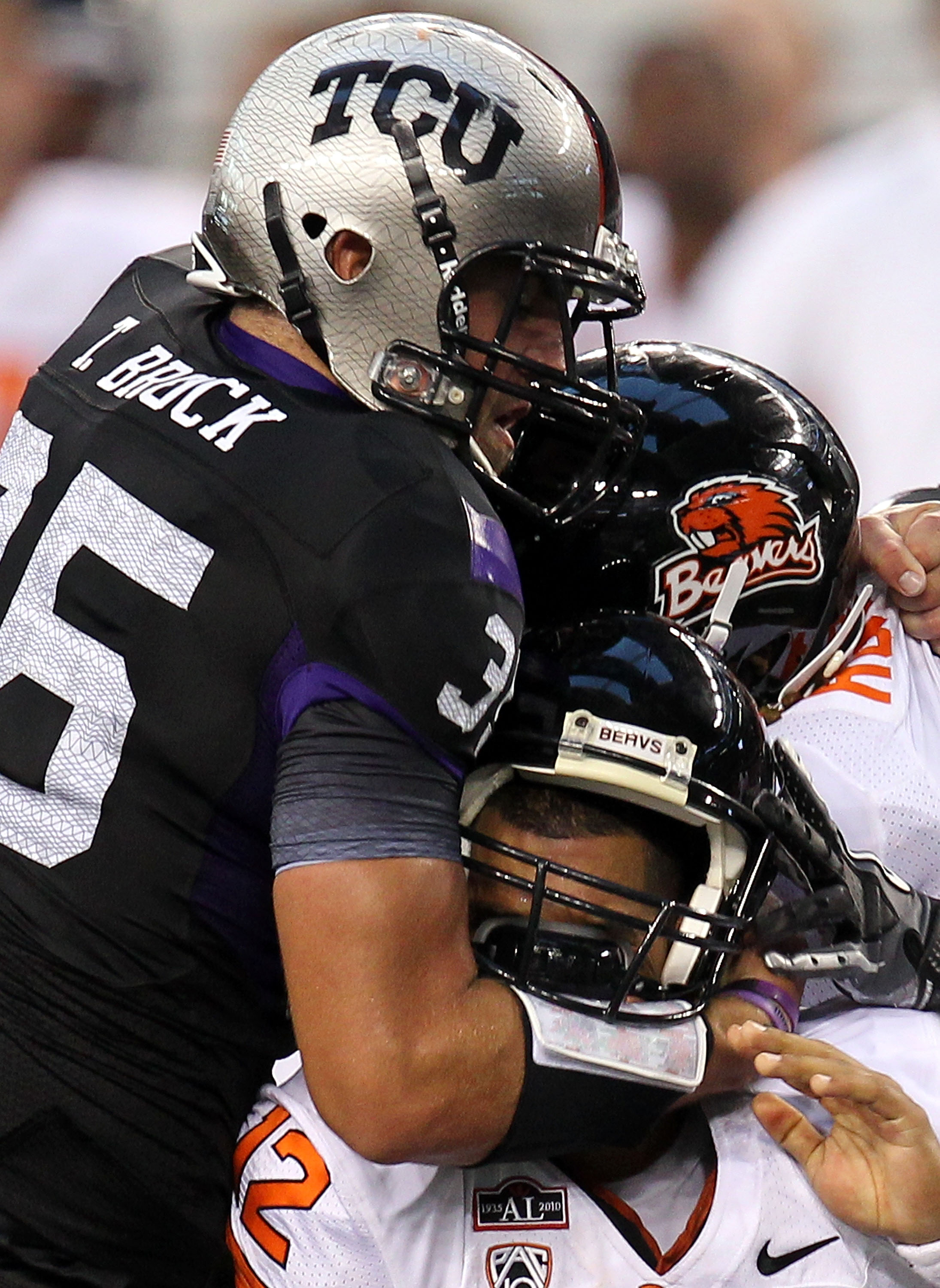 ARLINGTON, TX - SEPTEMBER 04:  Quarterback Ryan Katz #12 of the Oregon State Beavers is tackled by Tanner Brock #35 of the TCU Horned Frogs at Cowboys Stadium on September 4, 2010 in Arlington, Texas.  (Photo by Ronald Martinez/Getty Images)