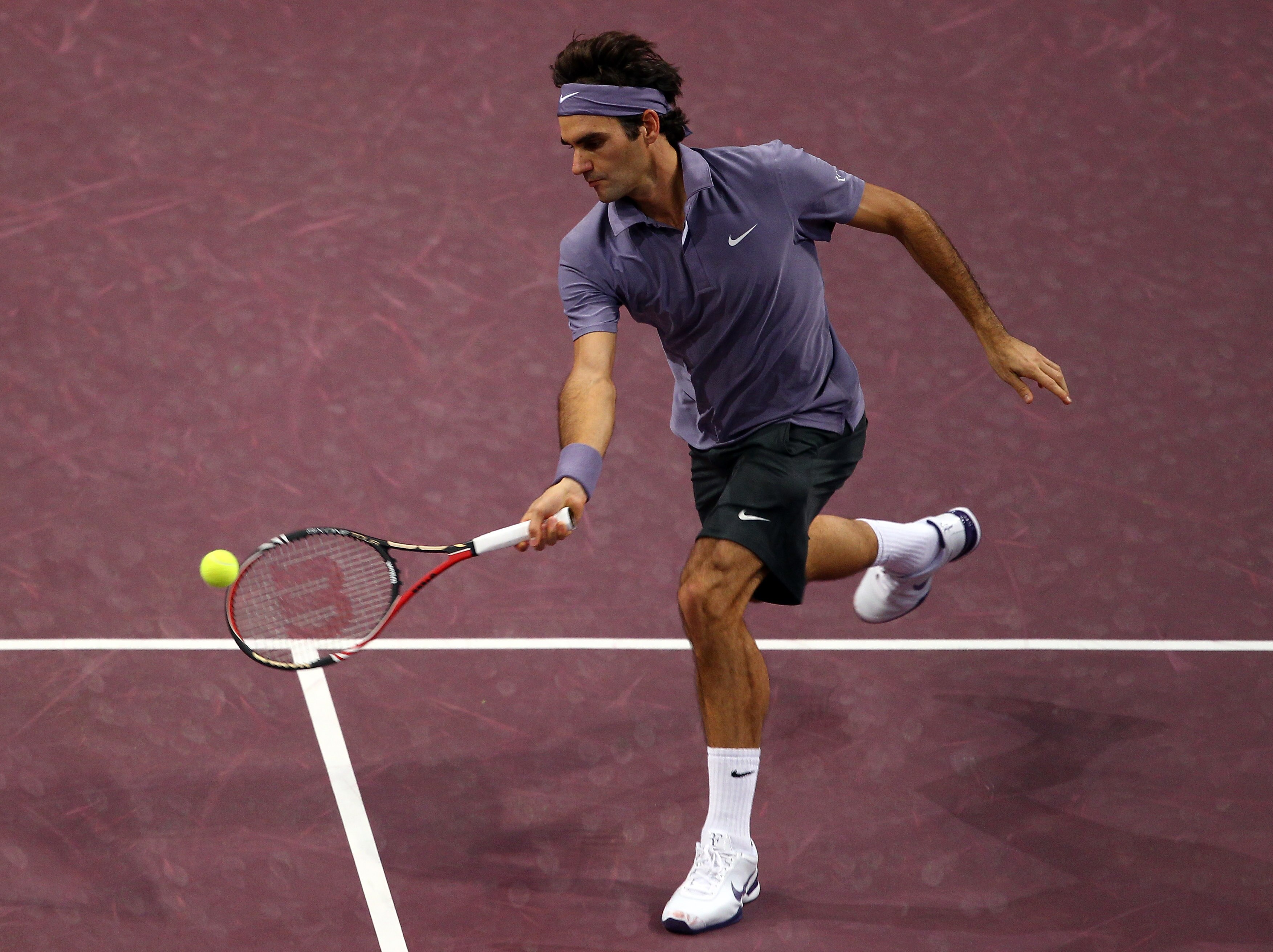 BASEL, SWITZERLAND - NOVEMBER 03:  Roger Federer of Switzerland plays a volley in his match against Janko Tipsarevic of Serbia during Day Three of the Davidoff Swiss Indoors Tennis at St Jakobshalle on November 3, 2010 in Basel, Switzerland.  (Photo by Ju