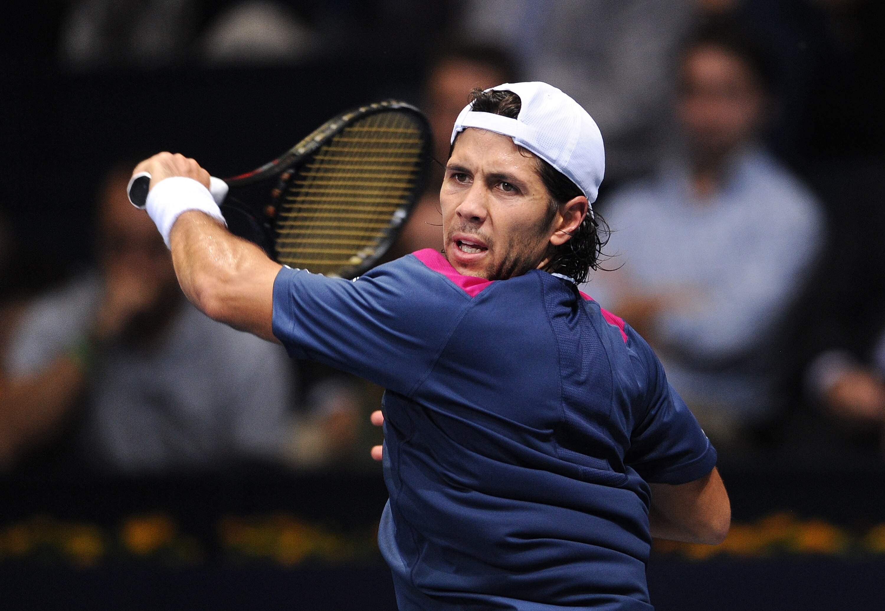 VALENCIA, SPAIN - NOVEMBER 03:  Fernando Verdasco of Spain follows the ball to Giles Simon of France in his first round match during the ATP 500 World Tour Valencia Open tennis tournament at the Ciudad de las Artes y las Ciencias on November 3, 2010 in Va