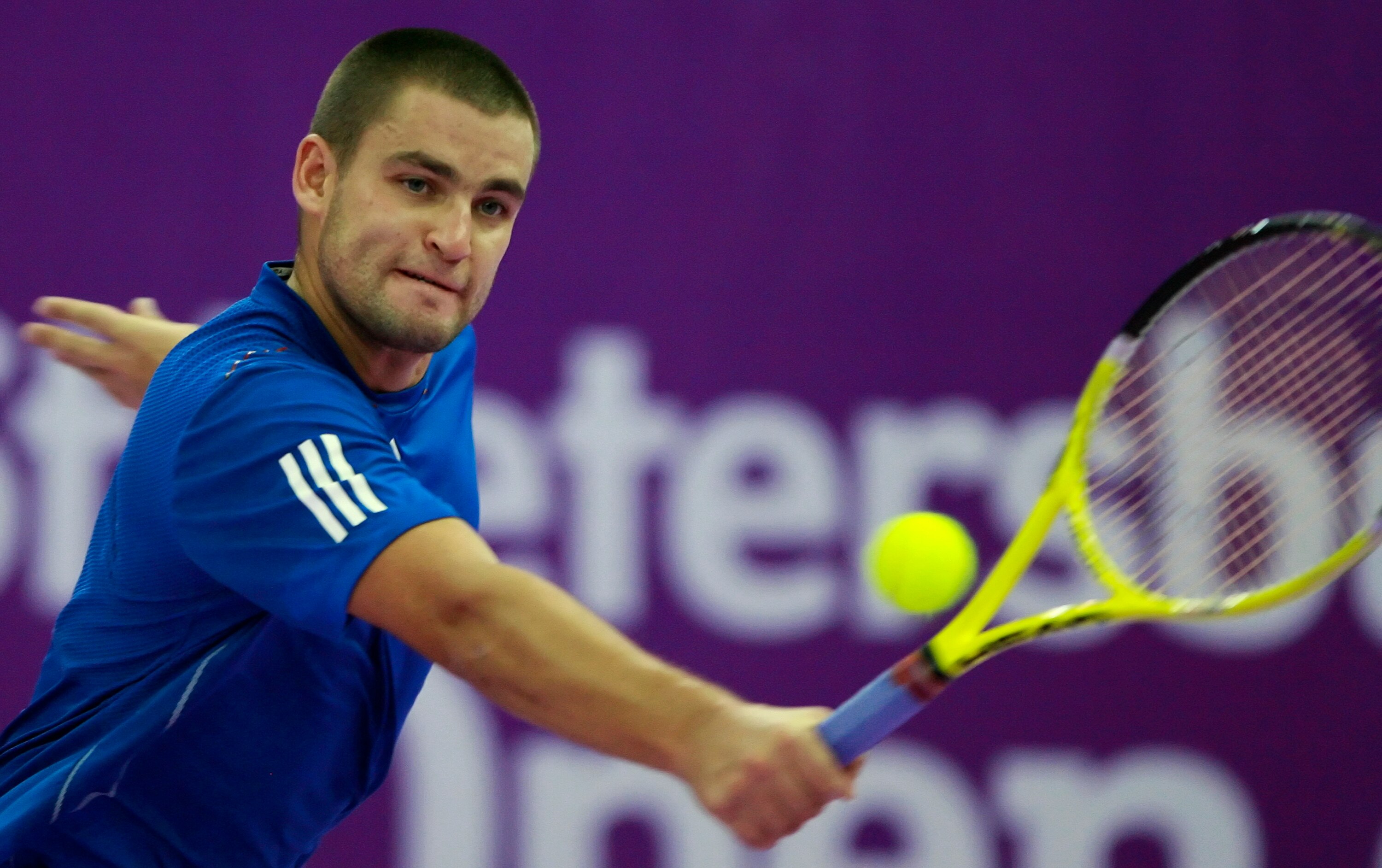 ST. PETERSBURG, RUSSIA - OCTOBER 31: Mikhail Youzhny of Russia plays against Mikhail Kukushkin of Kazakhstan during the singles final of the International Tennis Tournamen St. Petersburg Open 2010 at the Petersburgsky Sports Complex on October 31, 2010 in