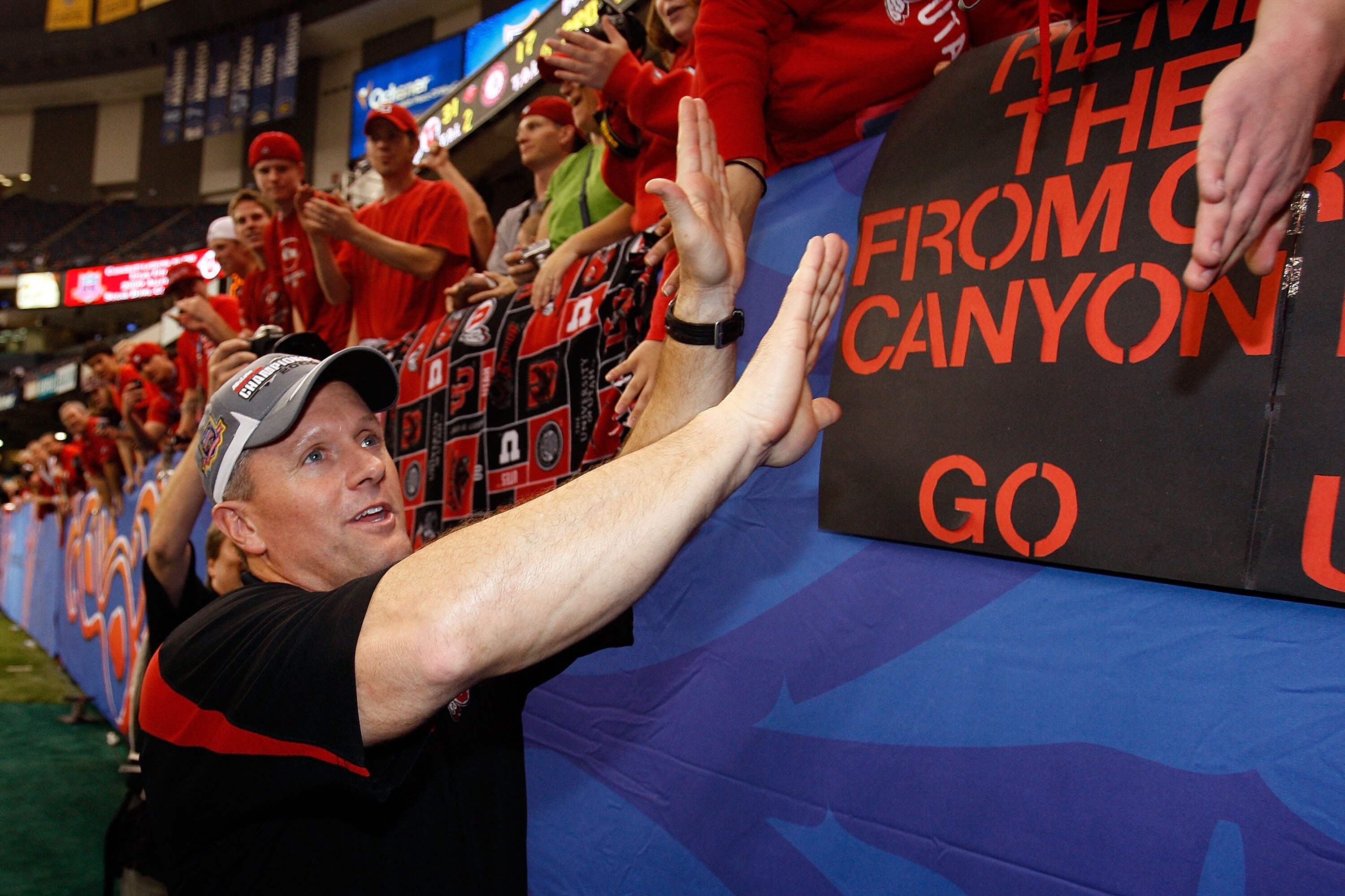 NEW ORLEANS - JANUARY 02:  Head coach Kyle Whittingham of the Utah Utes celebrates with the fans after defeating the Alabama Crimson Tide 31-17 during the 75th Allstate Sugar Bowl at the Louisiana Superdome on January 2, 2009 in New Orleans, Louisiana.  (