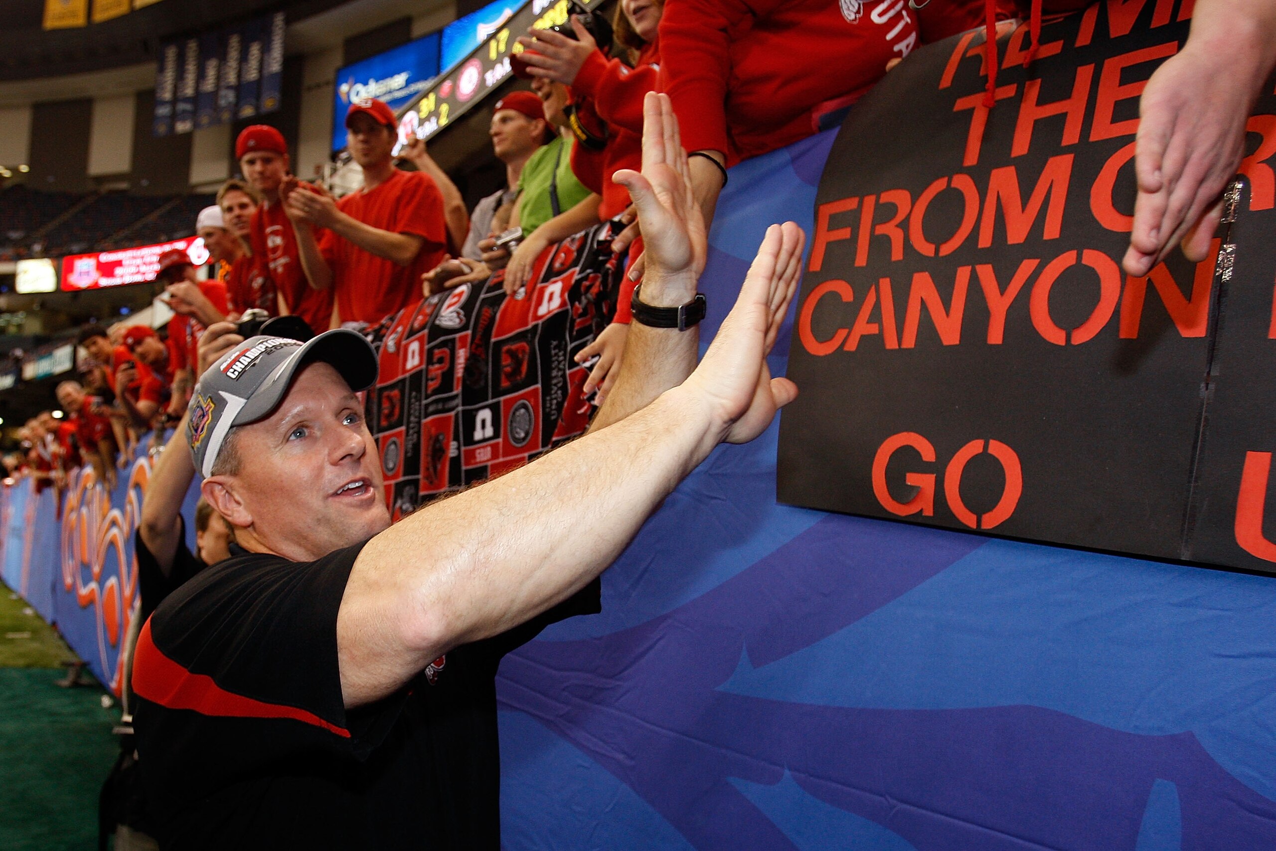 NEW ORLEANS - JANUARY 02:  Head coach Kyle Whittingham of the Utah Utes celebrates with the fans after defeating the Alabama Crimson Tide 31-17 during the 75th Allstate Sugar Bowl at the Louisiana Superdome on January 2, 2009 in New Orleans, Louisiana.  (