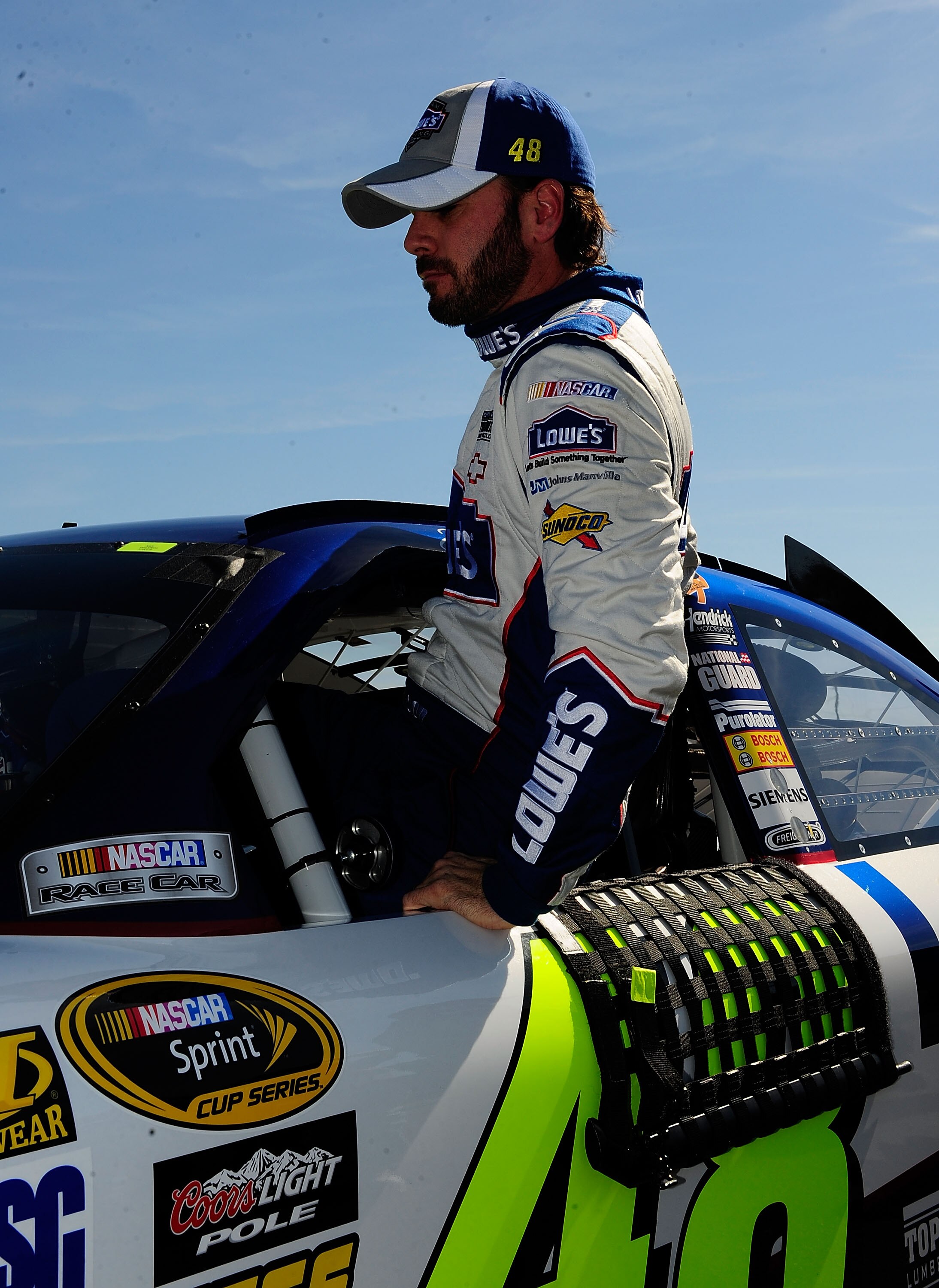 TALLADEGA, AL - OCTOBER 30:  Jimmie Johnson, driver of the #48 Lowe's Chevrolet, climbs out of his car after qualifying for the NASCAR Sprint Cup Series AMP Energy Juice 500 at Talladega Superspeedway on October 30, 2010 in Talladega, Alabama.  (Photo by