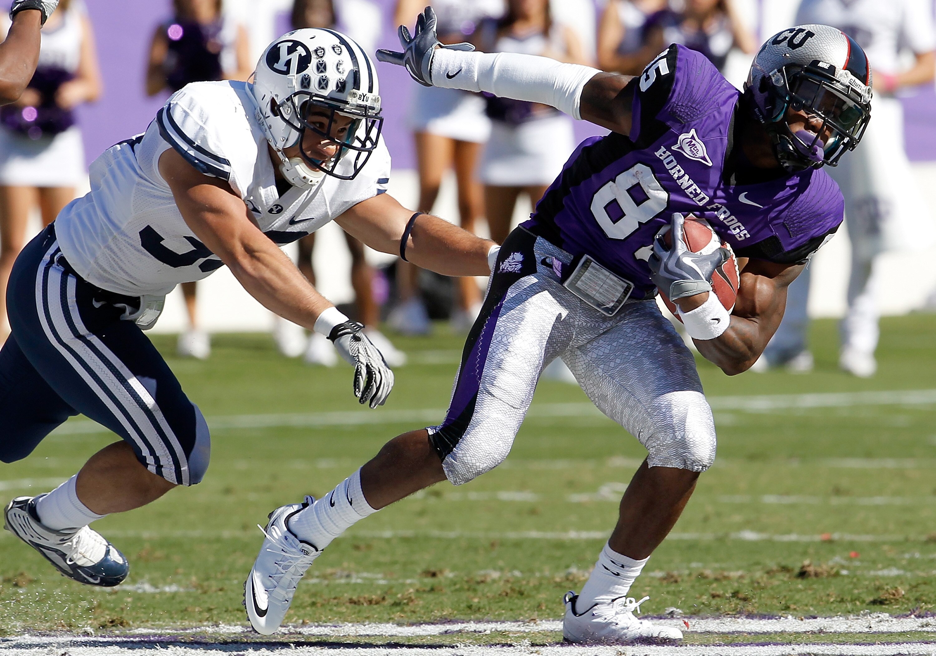 FORT WORTH, TX - OCTOBER 16:  Wide receiver Jeremy Kerley #85 of the TCU Horned Frogs carries the ball against defensice back Bryan Kariya #33 of the BYU Cougars at Amon G. Carter Stadium on October 16, 2010 in Fort Worth, Texas.  TCU beat BYU 31-3.  (Pho