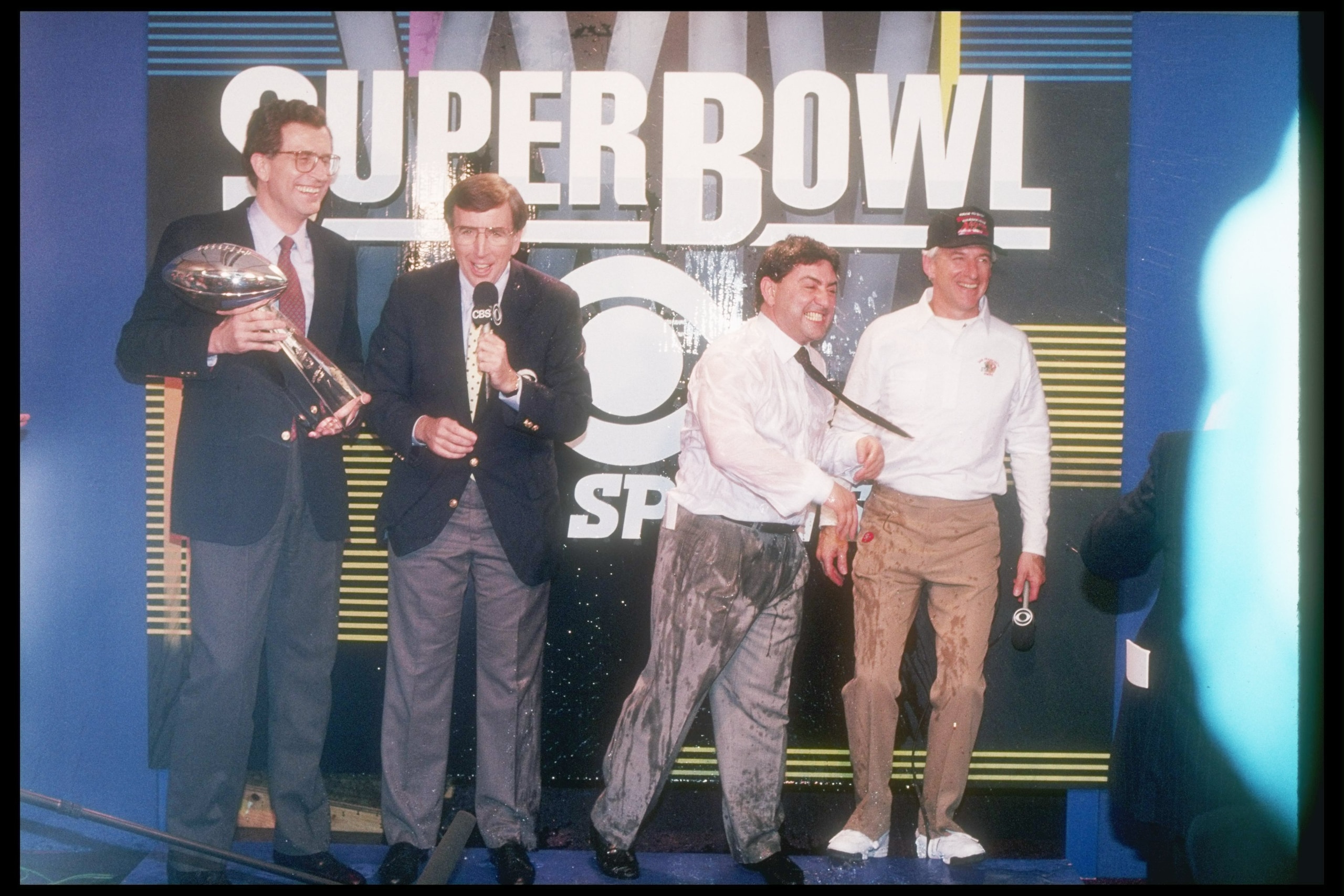 28 Jan 1990:  NFL Commissioner Paul Tagliabue, Brent Musburger, 49ers owner Eddie DeBartolo, and Head coach George Seifert glory in the 55-10 victory of the 49ers over the Denver Broncos in Super Bowl XXIV at the Louisiana Superdome in New Orleans, Louisi