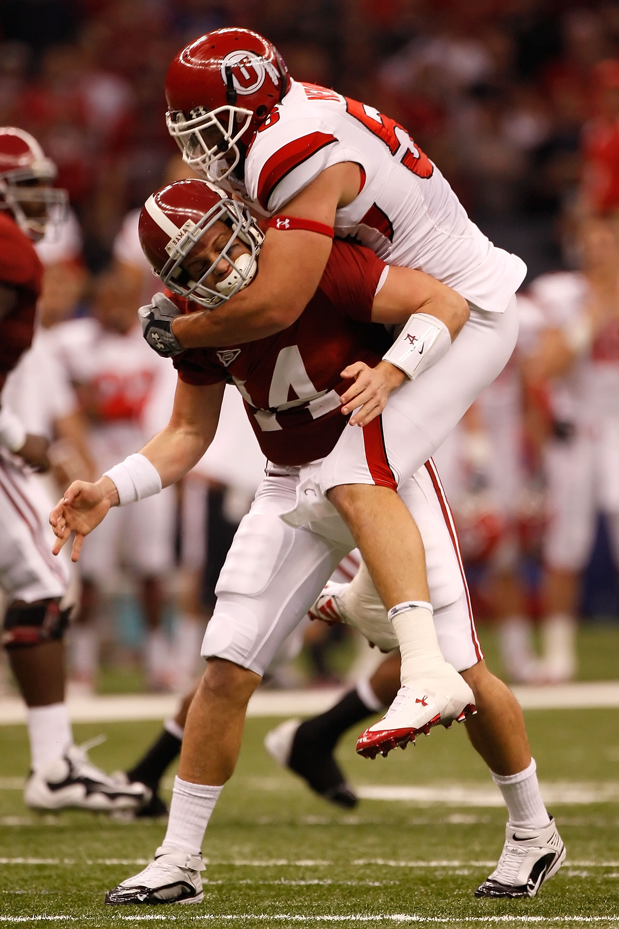 NEW ORLEANS - JANUARY 02: Quarterback John Parker Wilson #14 of the Alabama Crimson Tide is hit as he throws by defensive tackle Greg Newman #56 of the Utah Utes in the first quarter during the 75th Allstate Sugar Bowl at the Louisiana Superdome on Janua NEW ORLEANS - JANUARY 02: Quarterback John Parker Wilson #14 of the Alabama Crimson Tide is hit as he throws by defensive tackle Greg Newman #56 of the Utah Utes in the first quarter during the 75th Allstate Sugar Bowl at the Louisiana Superdome on Janua