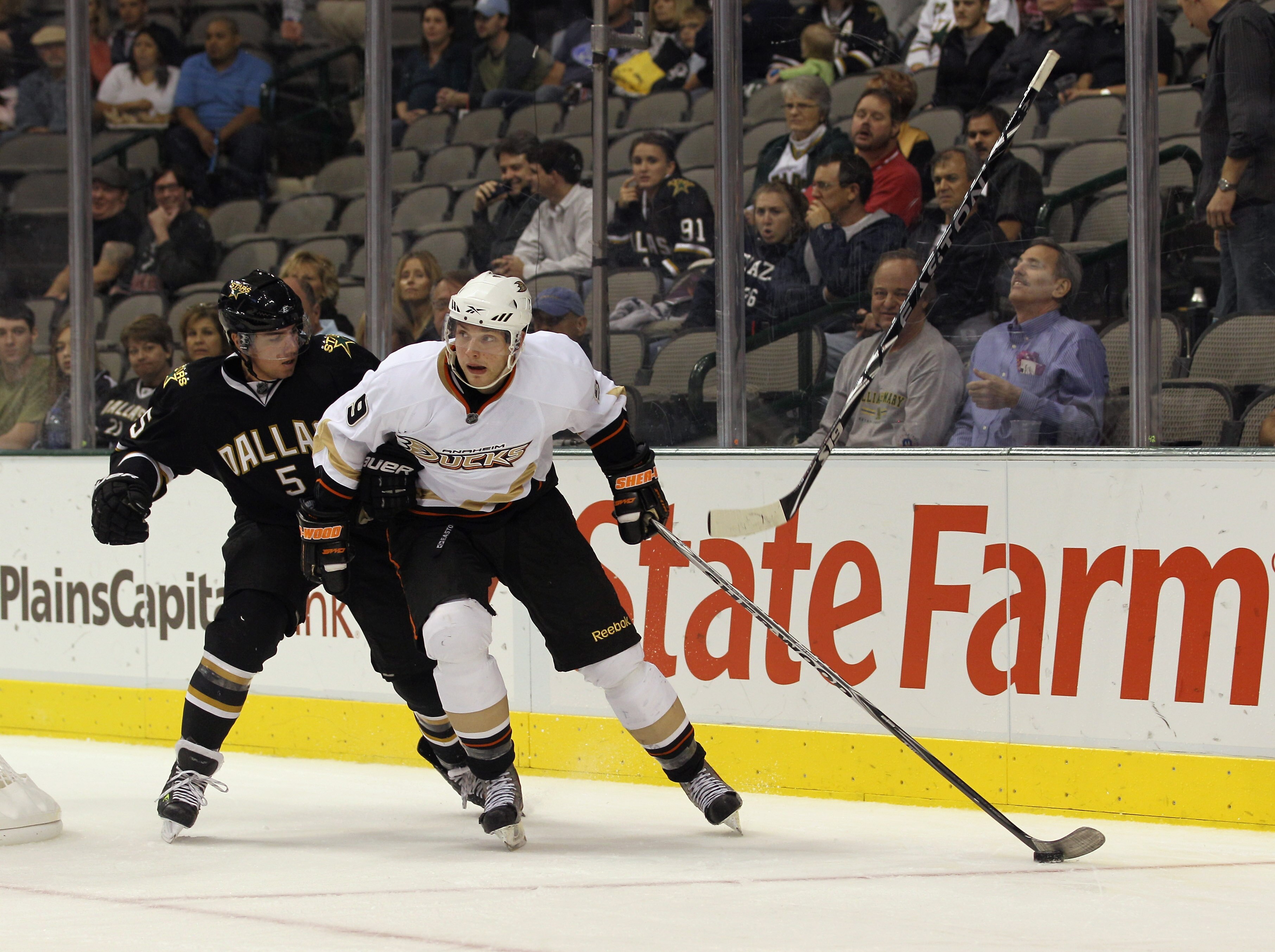 DALLAS - OCTOBER 26:  Bobby Ryan #9 of the Anaheim Ducks skates against Matt Niskanen #5 of the Dallas Stars as a Niskanen's stick goes airborne at the American Airlines Center on October 26, 2010 in Dallas, Texas. The Ducks defeated the Stars 5-2.  (Phot