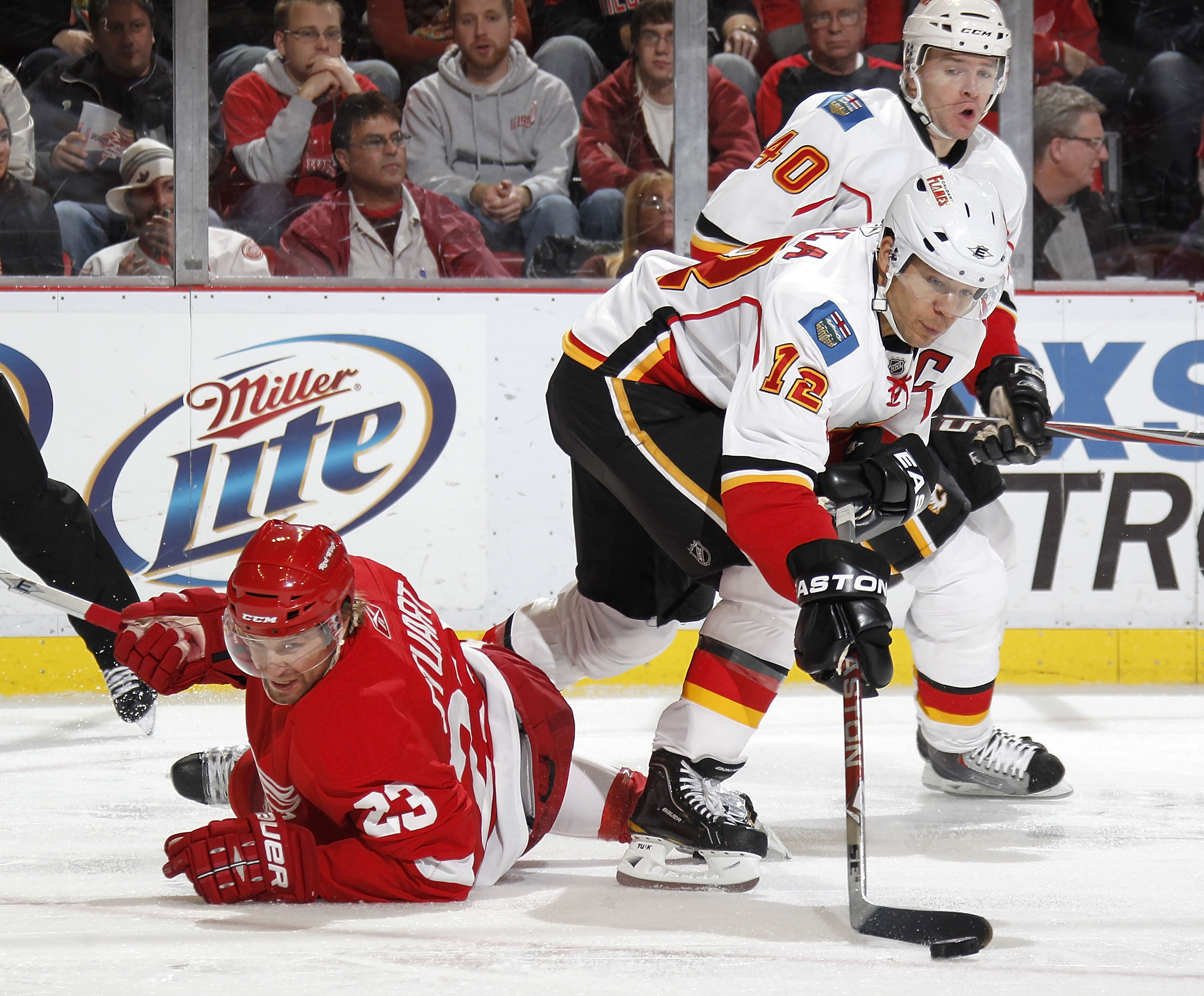 DETROIT - OCTOBER 21: Jarome Iginla #12 of the Calgary Flames controls the puck next to Brad Stuart #23 of the Detroit Red Wings on October 21, 2010 at Joe Louis Arena in Detroit, Michigan. Detroit won the game 4-2.  (Photo by Gregory Shamus/Getty Images)