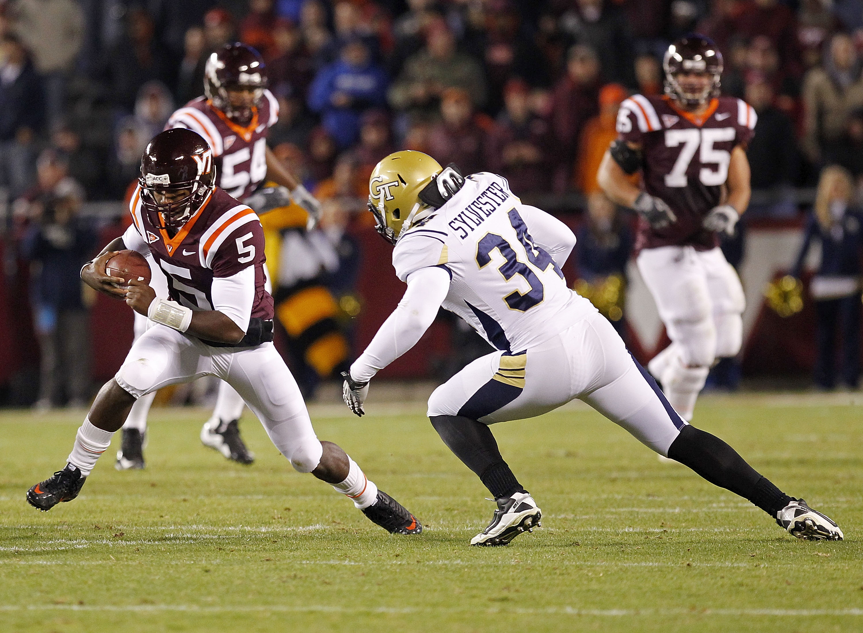 BLACKSBURG, VA - NOVEMBER 04: Quarterback Tyrod Taylor #5 of the Virginia Tech Hokies runs with the ball as linebacker Steven Sylvester #34 of the Georgia Tech Yellow Jackets chases at Lane Stadium on November 4, 2010 in Blacksburg, Virginia.  (Photo by G