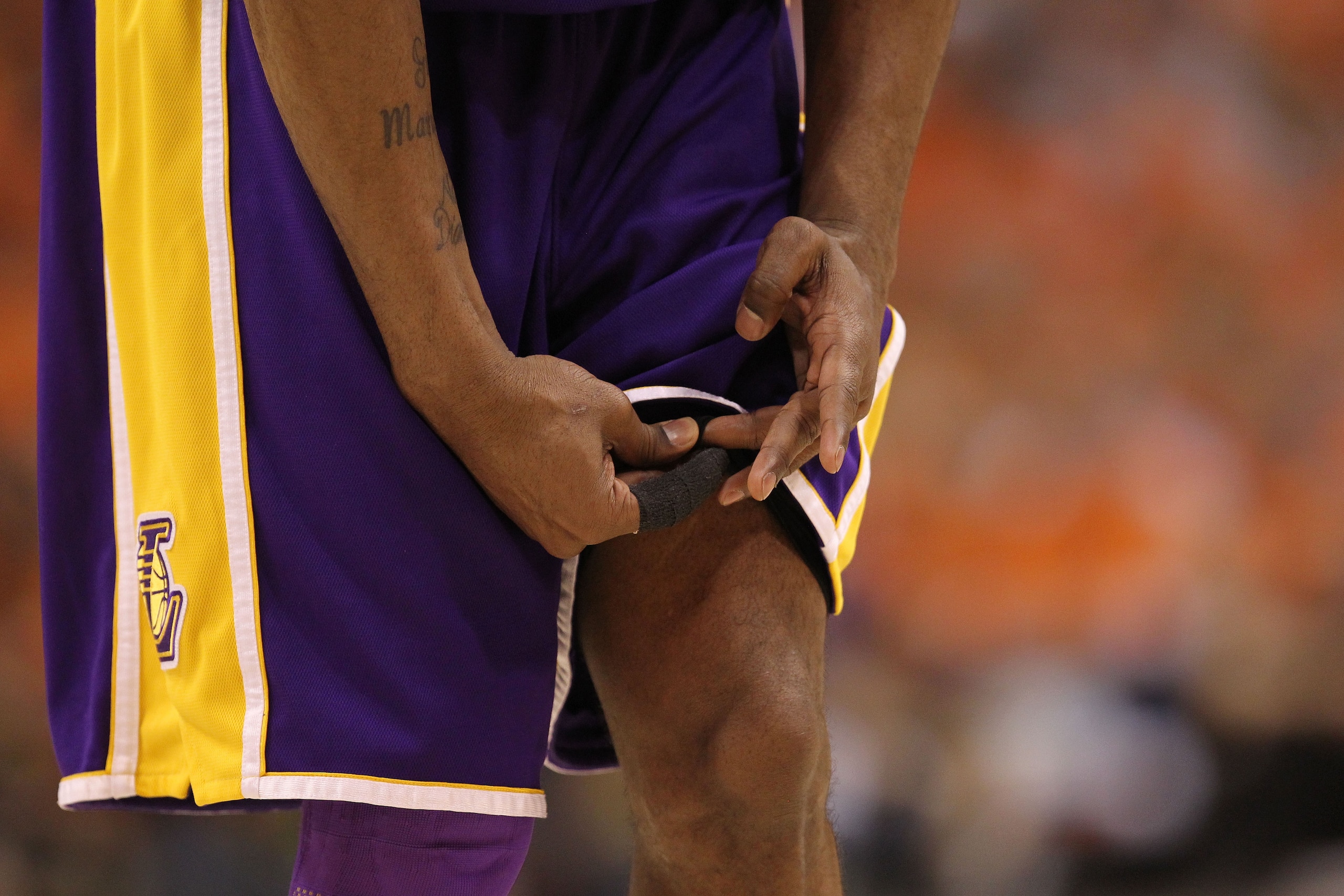 PHOENIX - MAY 29:  Kobe Bryant #24 of the Los Angeles Lakers wipes his finger on his shorts after cutting it in the first quarter of Game Six of the Western Conference Finals against the Phoenix Suns during the 2010 NBA Playoffs at US Airways Center on Ma