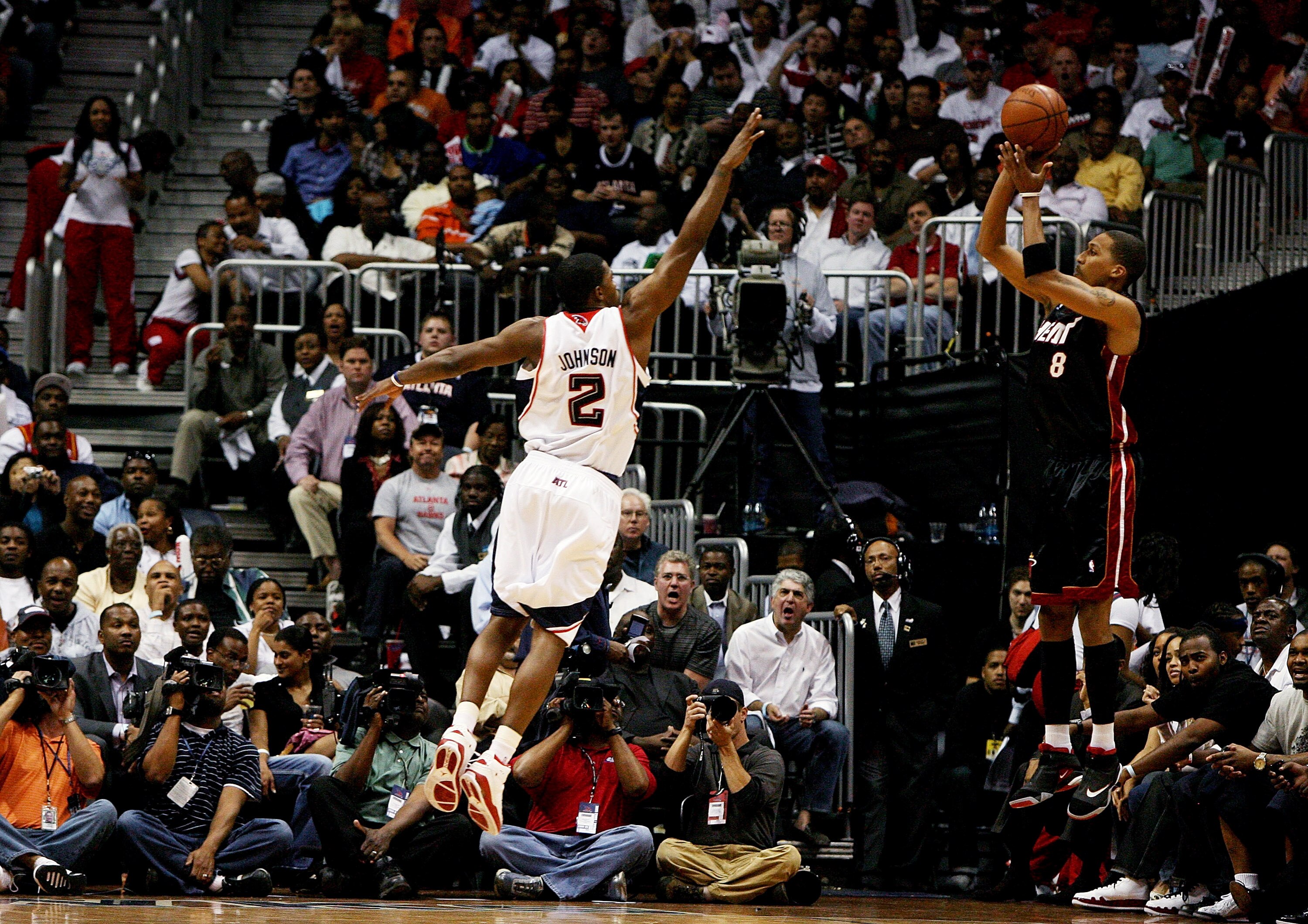 ATLANTA - APRIL 22:  Jamario Moon 38 of the Miami Heat hits a three-pointer as Joe Johnson #2 of the Atlanta Hawks gets a hand up during Game Two of the Eastern Conference Quarterfinals at Philips Arena on April 22, 2009 in Atlanta, Georgia. The Heat defe