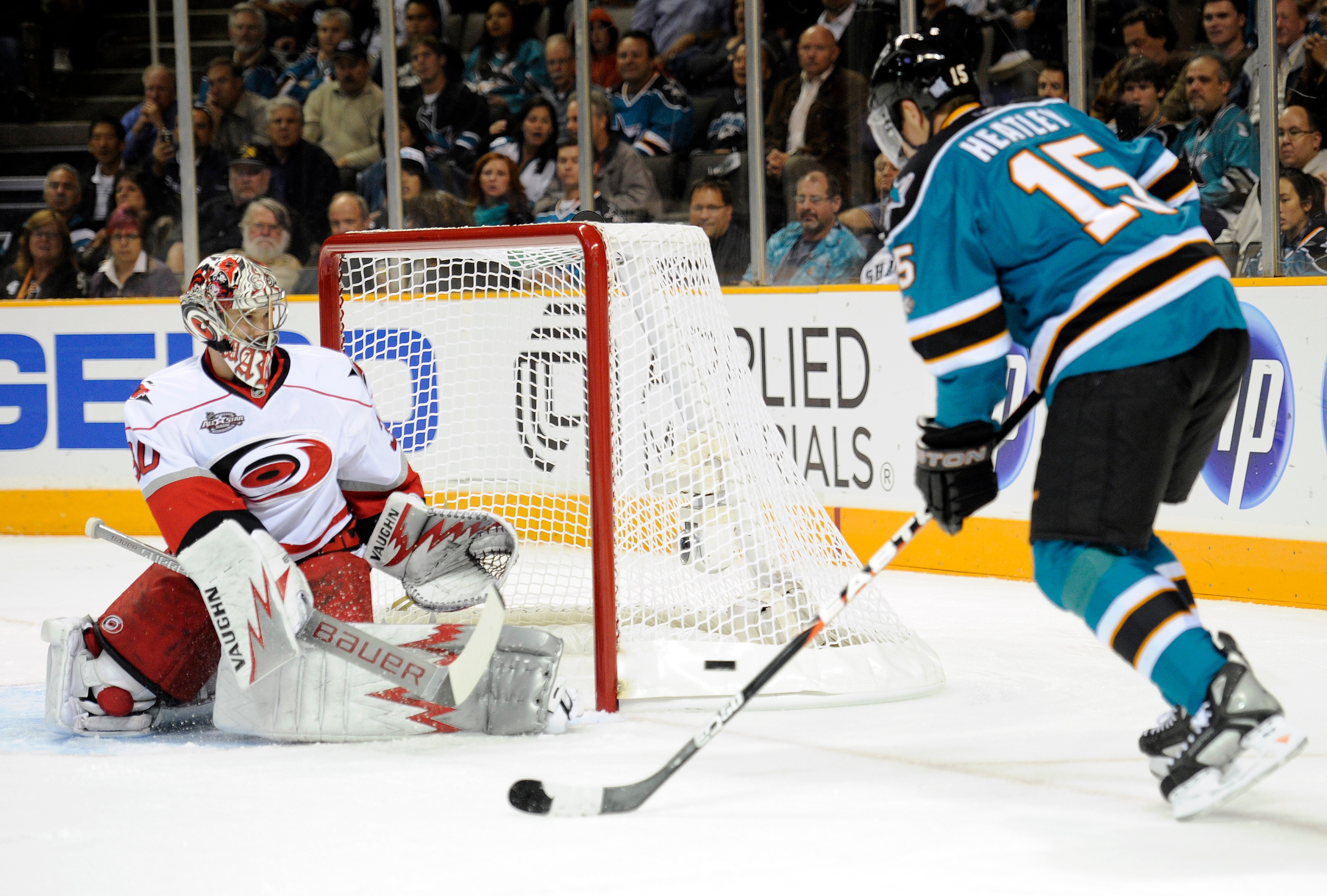 SAN JOSE, CA - OCTOBER 19:  Dany Heatley #15 of the San Jose Sharks has his shot deflected by goalie Cam Ward #30 of the Carolina Hurricanes during an NHL hockey game at the HP Pavilion October 19, 2010 in San Jose, California. (Photo by Thearon W. Hender