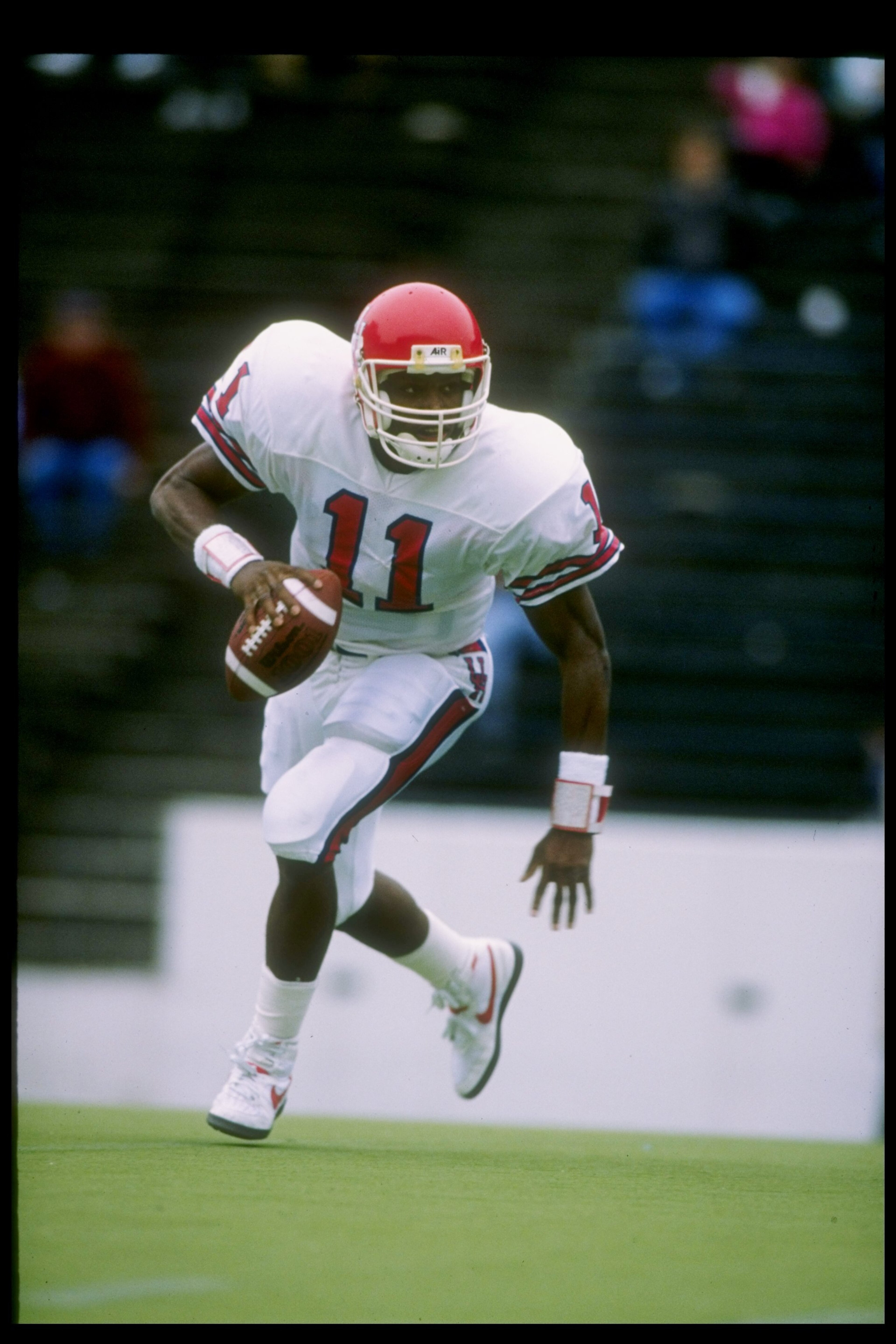 2 Dec 1989: Quarterback Andre Ware #11 of the Houston Cougars in action during a game against the Rice Owls in Houston, Texas. The Houston Cougars won the game 64-0. 2 Dec 1989: Quarterback Andre Ware #11 of the Houston Cougars in action during a game against the Rice Owls in Houston, Texas. The Houston Cougars won the game 64-0.