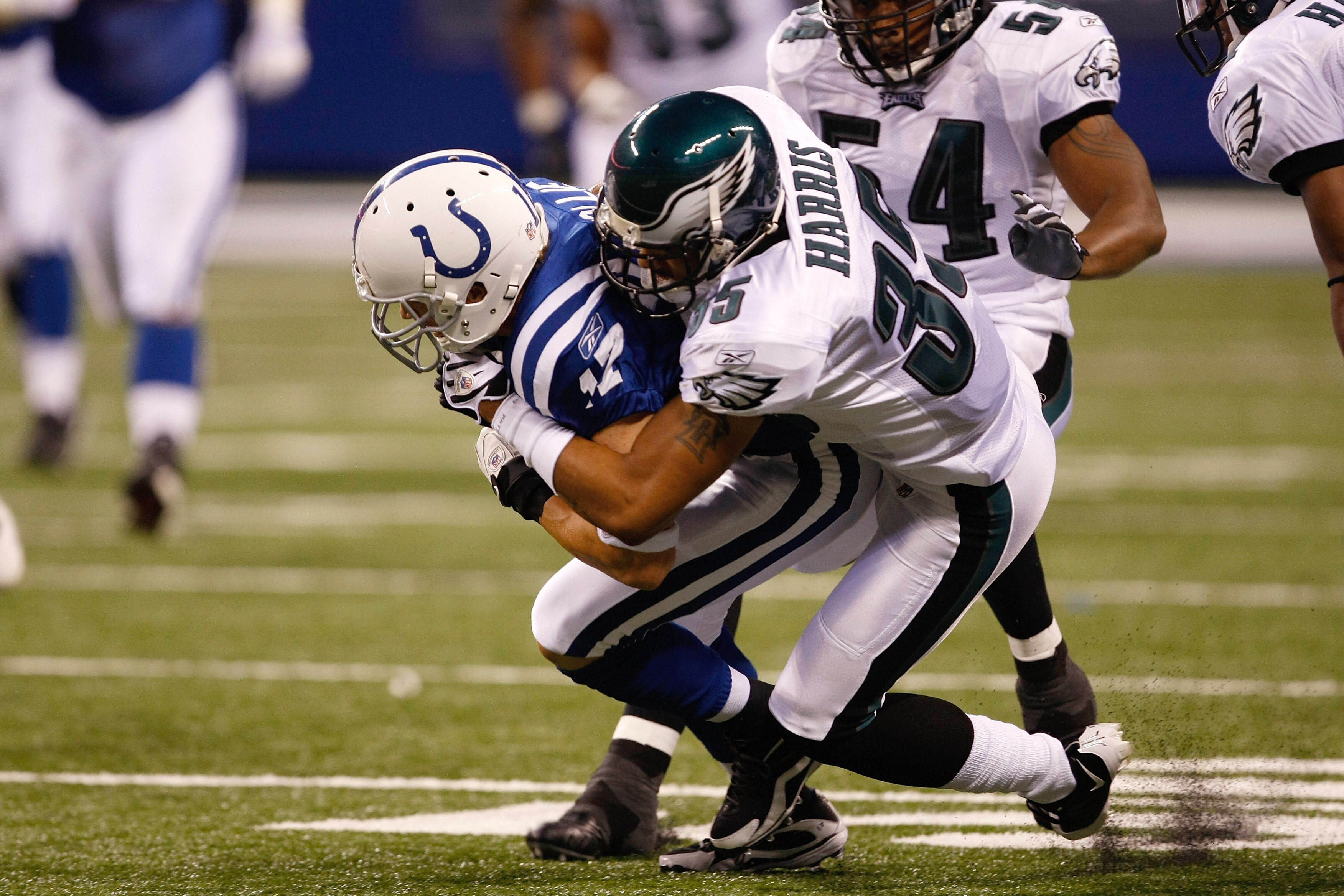 INDIANAPOLIS, IN - AUGUST 20: Wide receiver Austin Collie #17 of the Indianapolis Colts is tackled by defensive back Macho Harris #35 of the Philadelphia Eagles at Lucas Oil Stadium on August 20, 2009 in Indianapolis, Indiana. (Photo by Scott Boehm/Getty