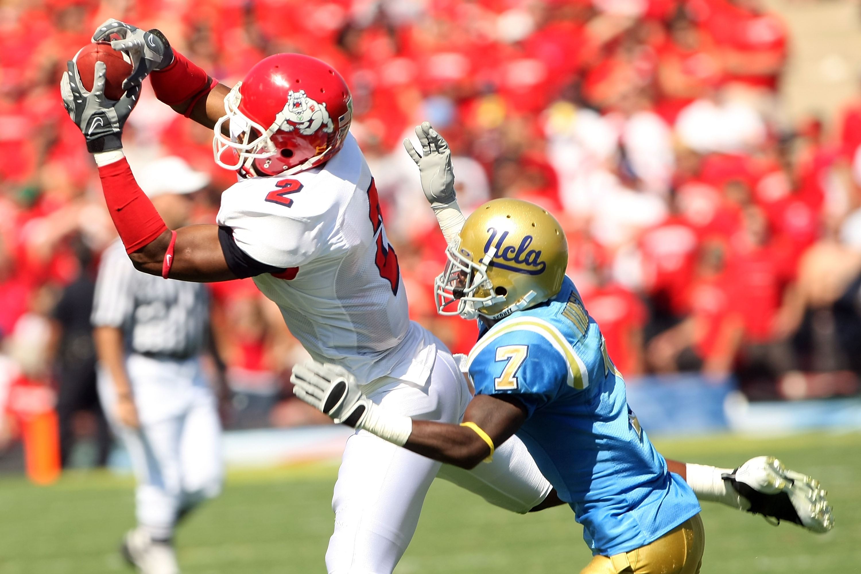 PASADENA, CA - SEPTEMBER 27: Seyi Ajirotutu #2 of the Frenso State Bulldogs catches a pass ahead of Courtney Viney #7 of the UCLA Bruins during the game on September 27, 2008 at the Rose Bowl in Pasadena, California.  (Photo by Stephen Dunn/Getty Images)