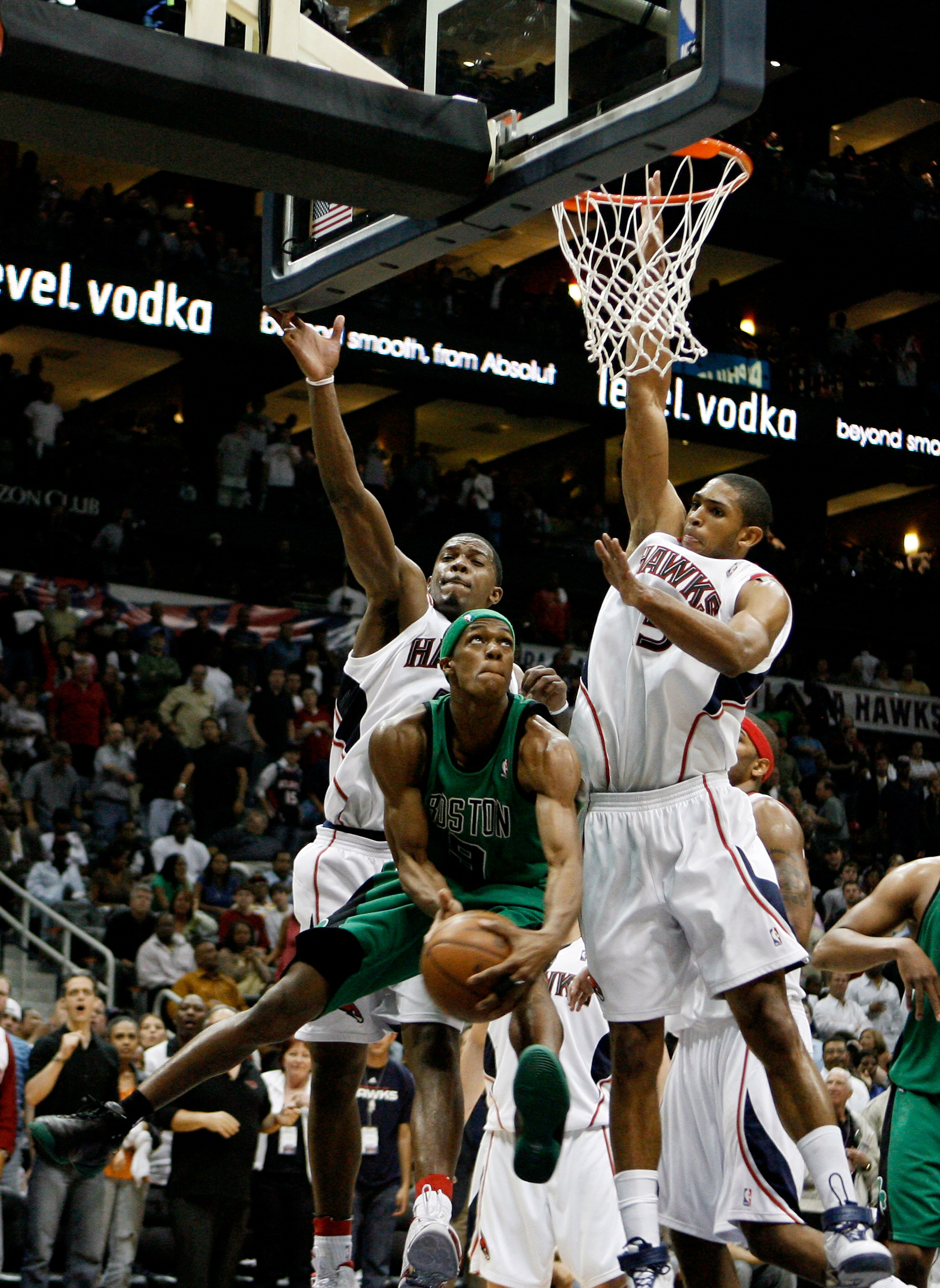 ATLANTA - APRIL 26:  Guard Rajon Rondo #9 of the Boston Celtics tries to score around defenders Al Horford #15 and Joe Johnson #2 of the Atlanta Hawks during Game Three of the Eastern Conference Quarterfinals against the Atlanta Hawks during the 2008 NBA 