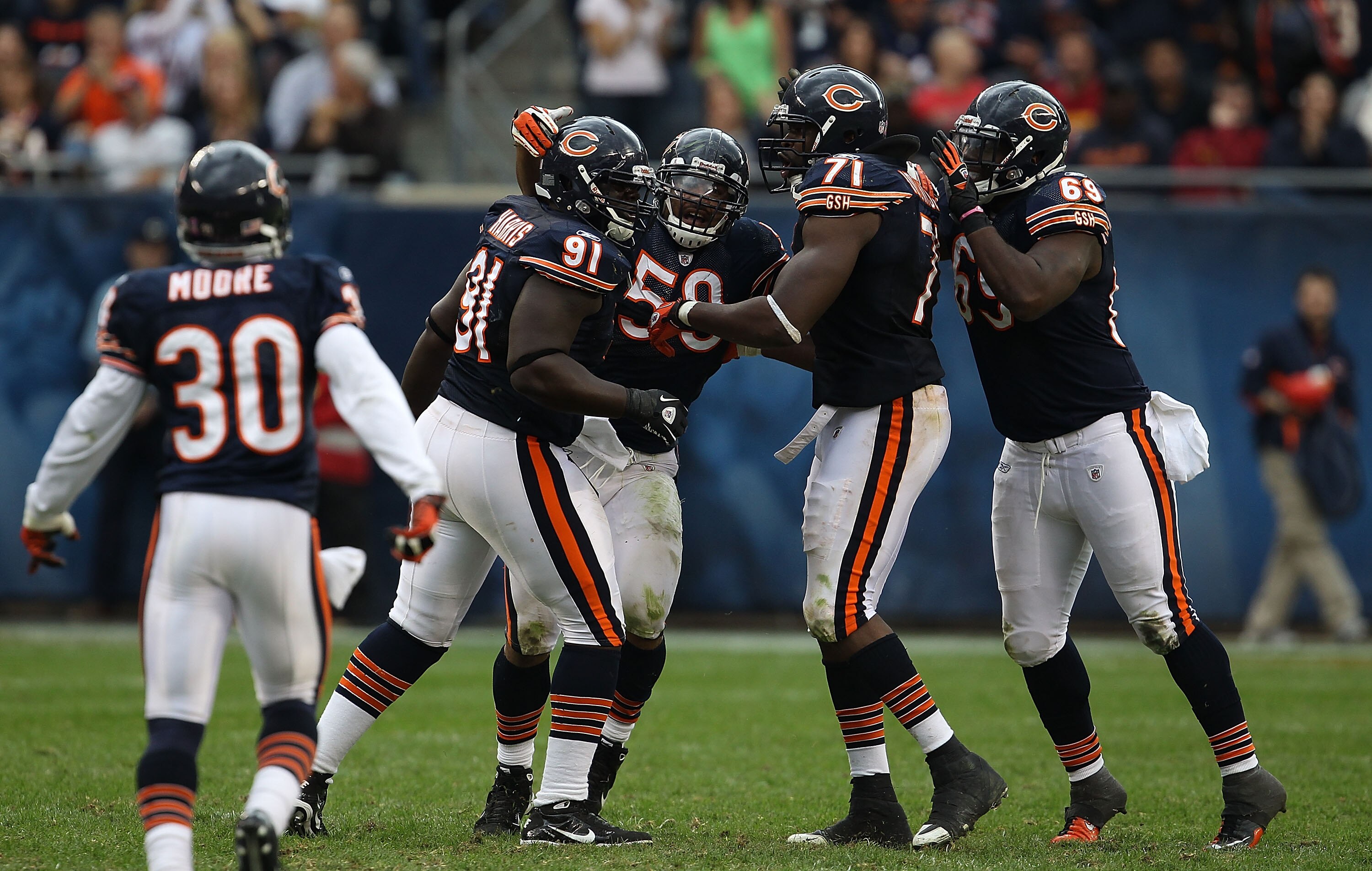 CHICAGO - OCTOBER 24: (L-R) D.J. Moore #30, Tommie Harris #91, Rod Wilson #58, Israel Idonije #71 and Henry Melton #69 of the Chicago Bears celebrate a defensive stop against the Washington Redskins at Soldier Field on October 24, 2010 in Chicago, Illinoi