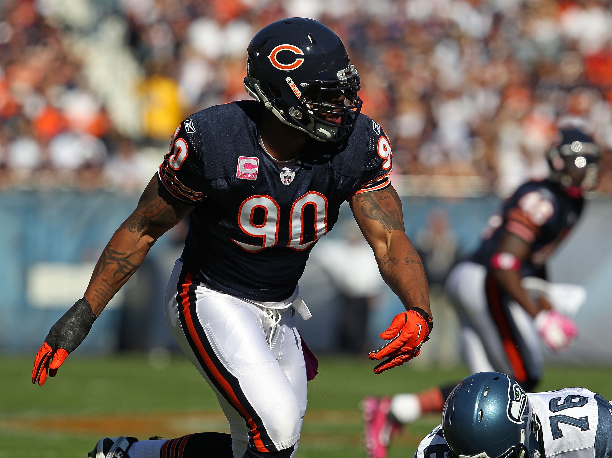 CHICAGO - OCTOBER 17: Julius Peppers #90 of the Chicago Bears rushes against Russell Okung #76 of the Seattle Seahawks at Soldier Field on October 17, 2010 in Chicago, Illinois. The Seahawks defeated the Bears 23-20. (Photo by Jonathan Daniel/Getty Images