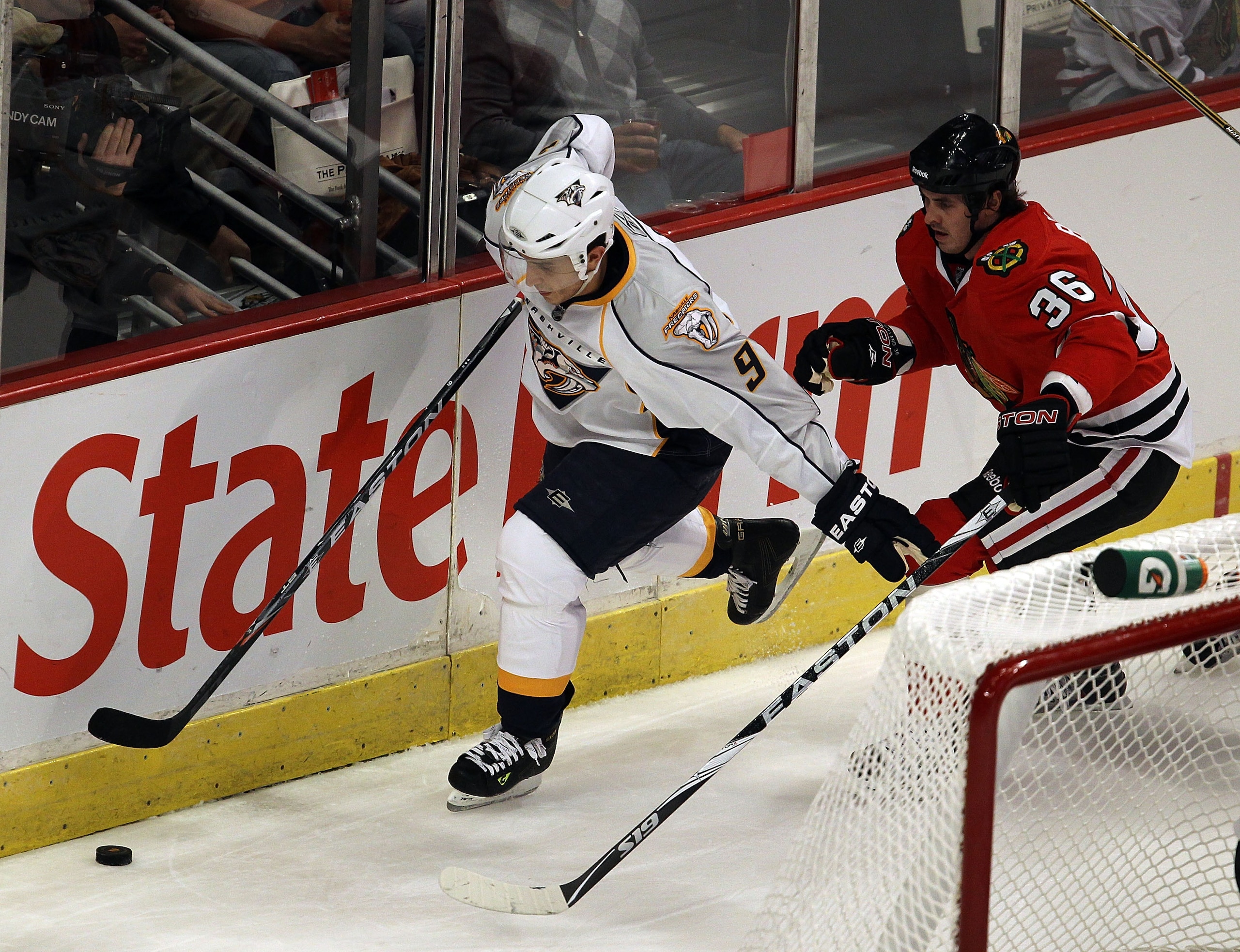 CHICAGO - OCTOBER 13: Marcel Goc #9 of the Nashville Predators chases down the puck in front of Dave Bolland #36 of the Chicago Blackhawks at the United Center on October 13, 2010 in Chicago, Illinois. The Predators defeated the Blackhawks 3-2.  (Photo by