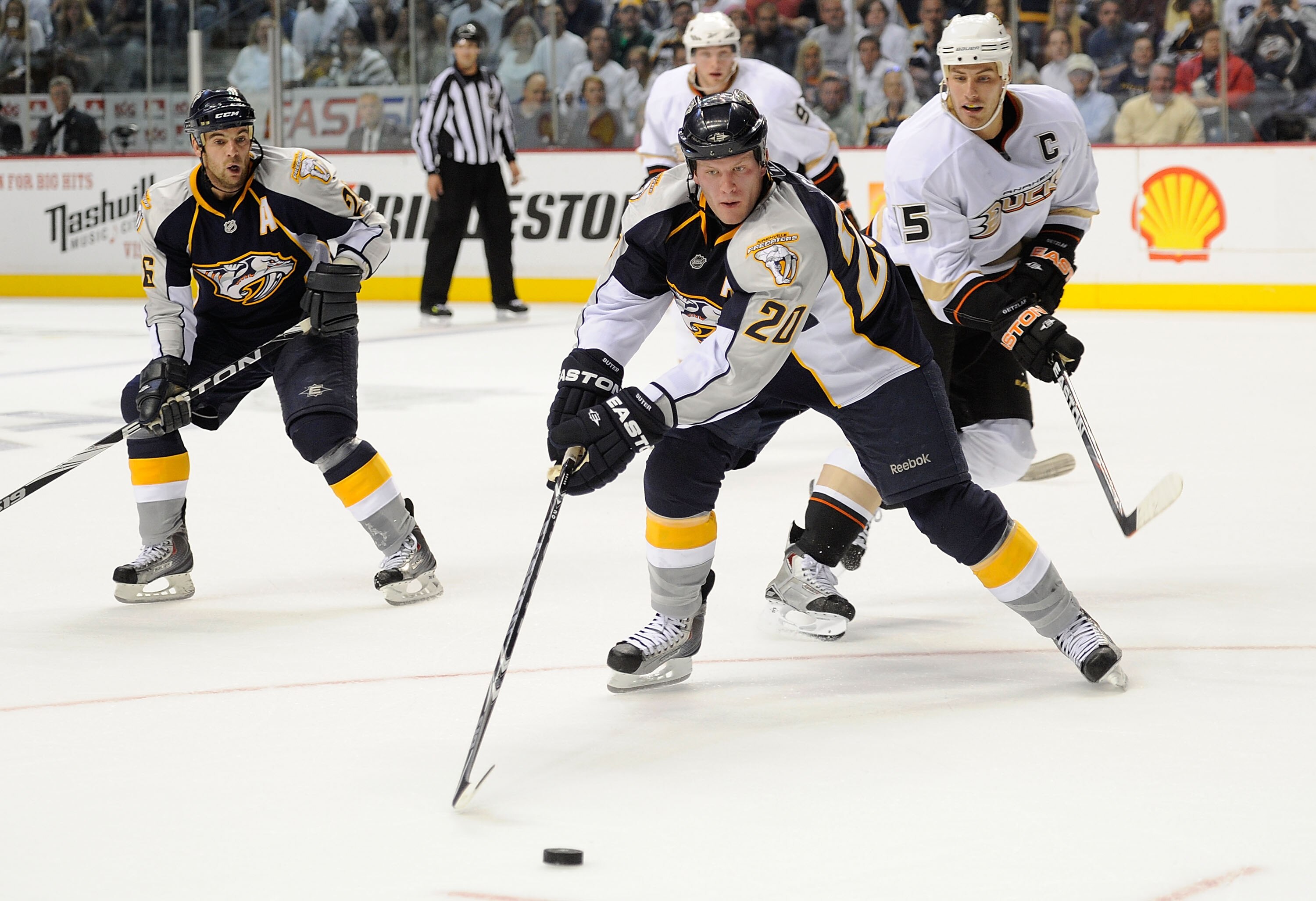 NASHVILLE, TN - OCTOBER 09:  Defenseman Ryan Suter #20 of the Nashville Predators carries the puck past Luca Sbisa #5 of the Anaheim Ducks on October 9, 2010 in Nashville, Tennessee.  (Photo by Frederick Breedon/Getty Images)