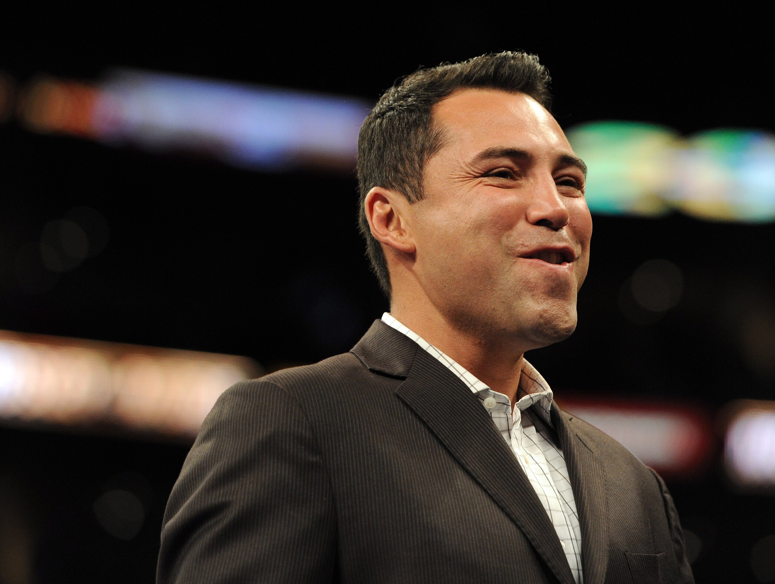 LOS ANGELES, CA - SEPTEMBER 18:  Oscar de la Hoya smiles before the Middleweight bout against Shane Mosley and Sergio Mora at Staples Center on September 18, 2010 in Los Angeles, California.  (Photo by Harry How/Getty Images)