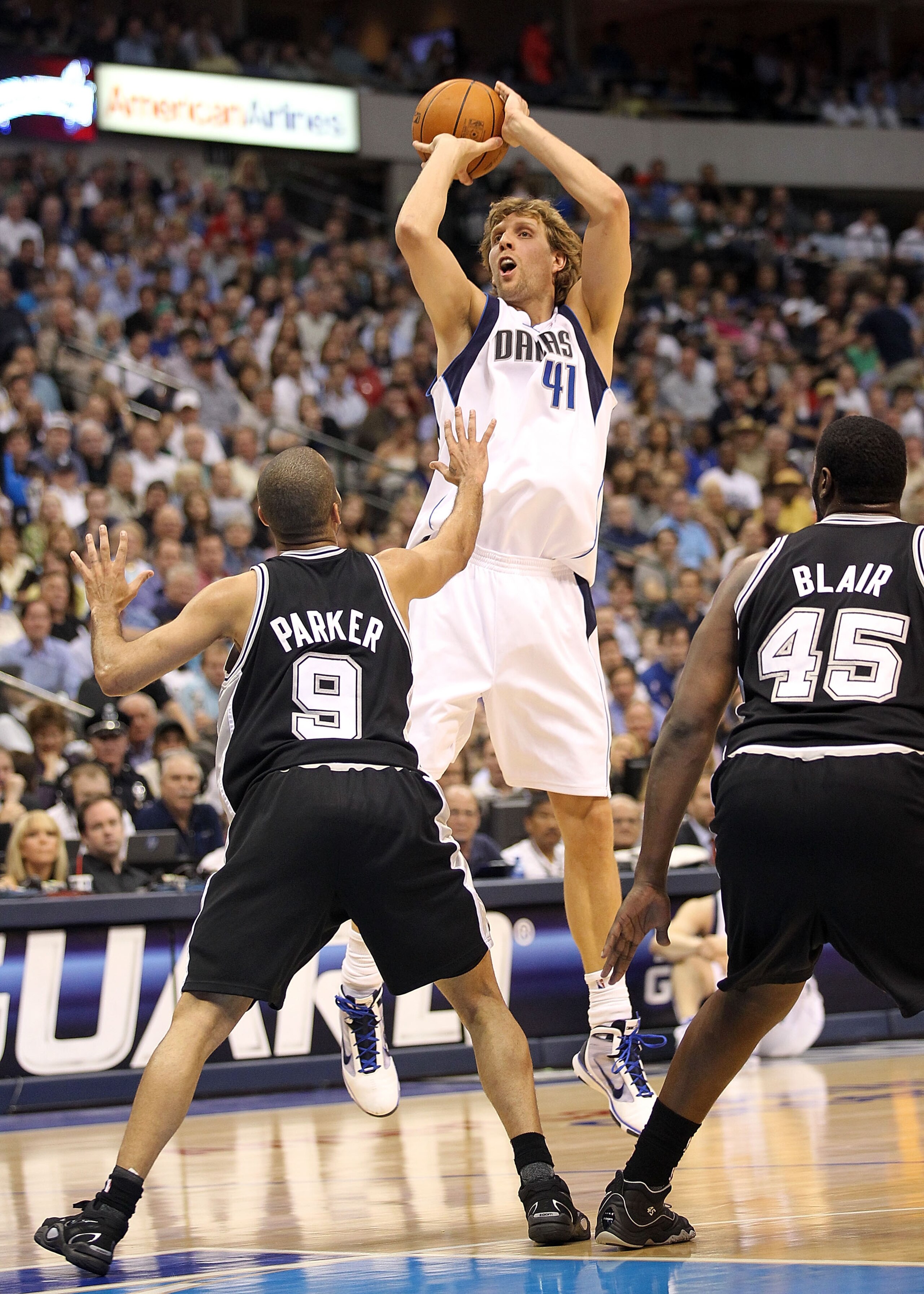 DALLAS - APRIL 21:  Forward Dirk Nowitzki #41 of the Dallas Mavericks takes a shot against Tony Parker #9 and DeJuan Blair #45 of the San Antonio Spurs in Game Two of the Western Conference Quarterfinals during the 2010 NBA Playoffs at American Airlines C
