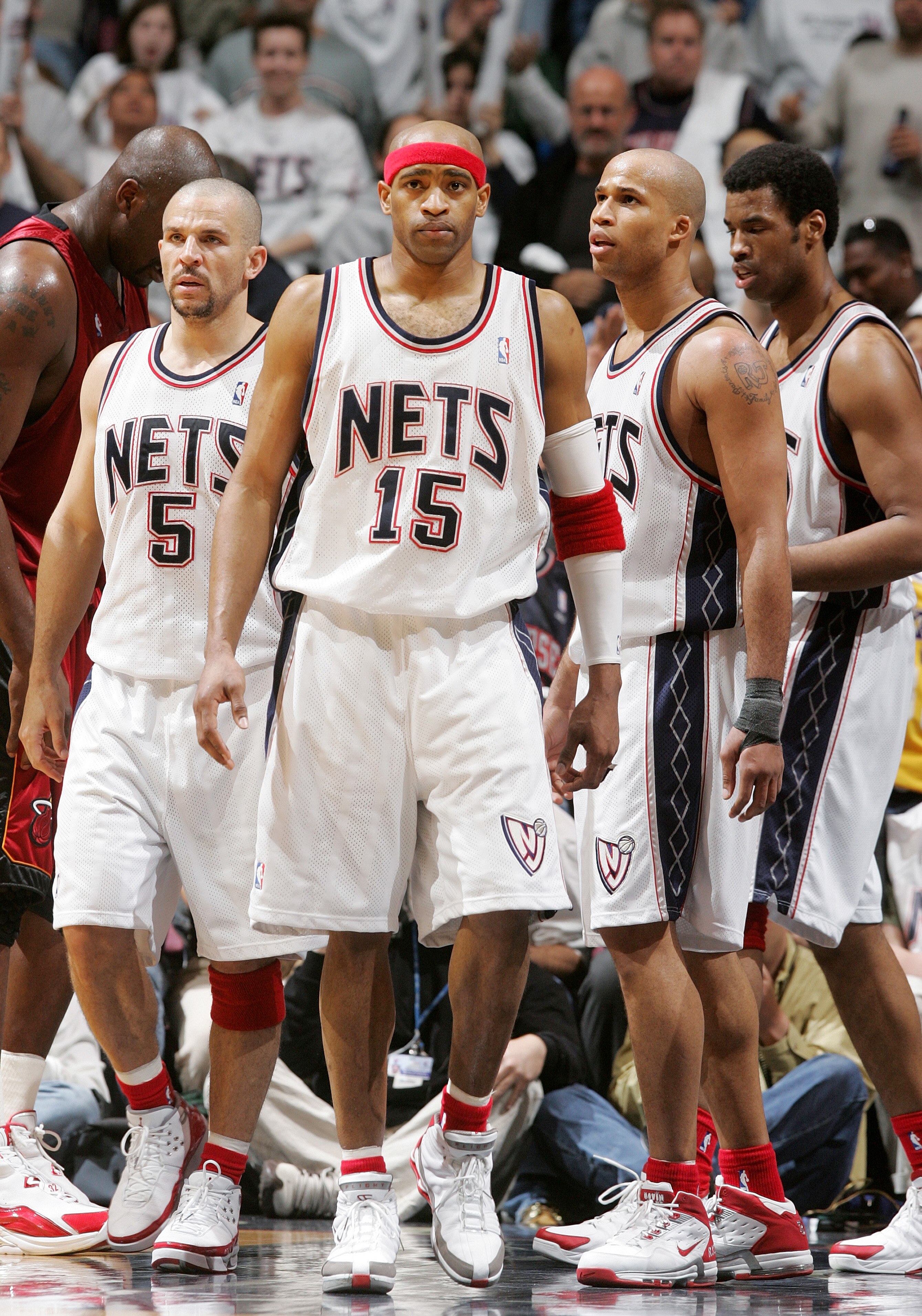 EAST RUTHERFORD - APRIL 28:  New Jersey Nets Jason Kidd #5, Vince Carter #15, and Richard Jefferson #24 look on against the Miami Heat in Game three of the Eastern Conference Quarterfinals during the 2005 NBA Playoffs April 28, 2005 at Continental Airline
