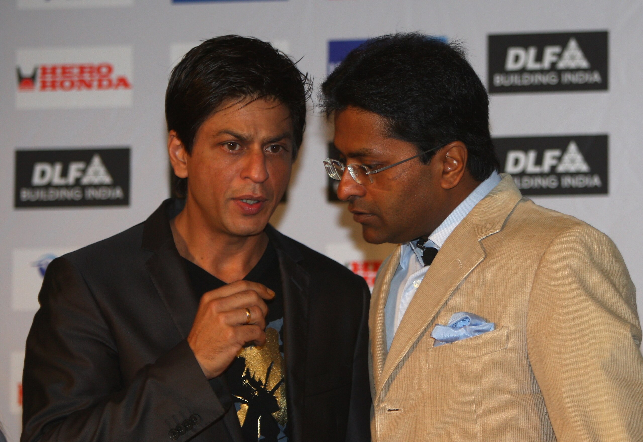 CAPE TOWN, SOUTH AFRICA - APRIL 16:  Lalit Modi (R),  the Chairman of the IPL, and Shah Rukh Khan, the owner of the Kolkata Knight Riders, have a chat at a press conference at the CTICC on April 16, 2009 in Cape Town, South Africa.  (Photo by Tom Shaw/Get