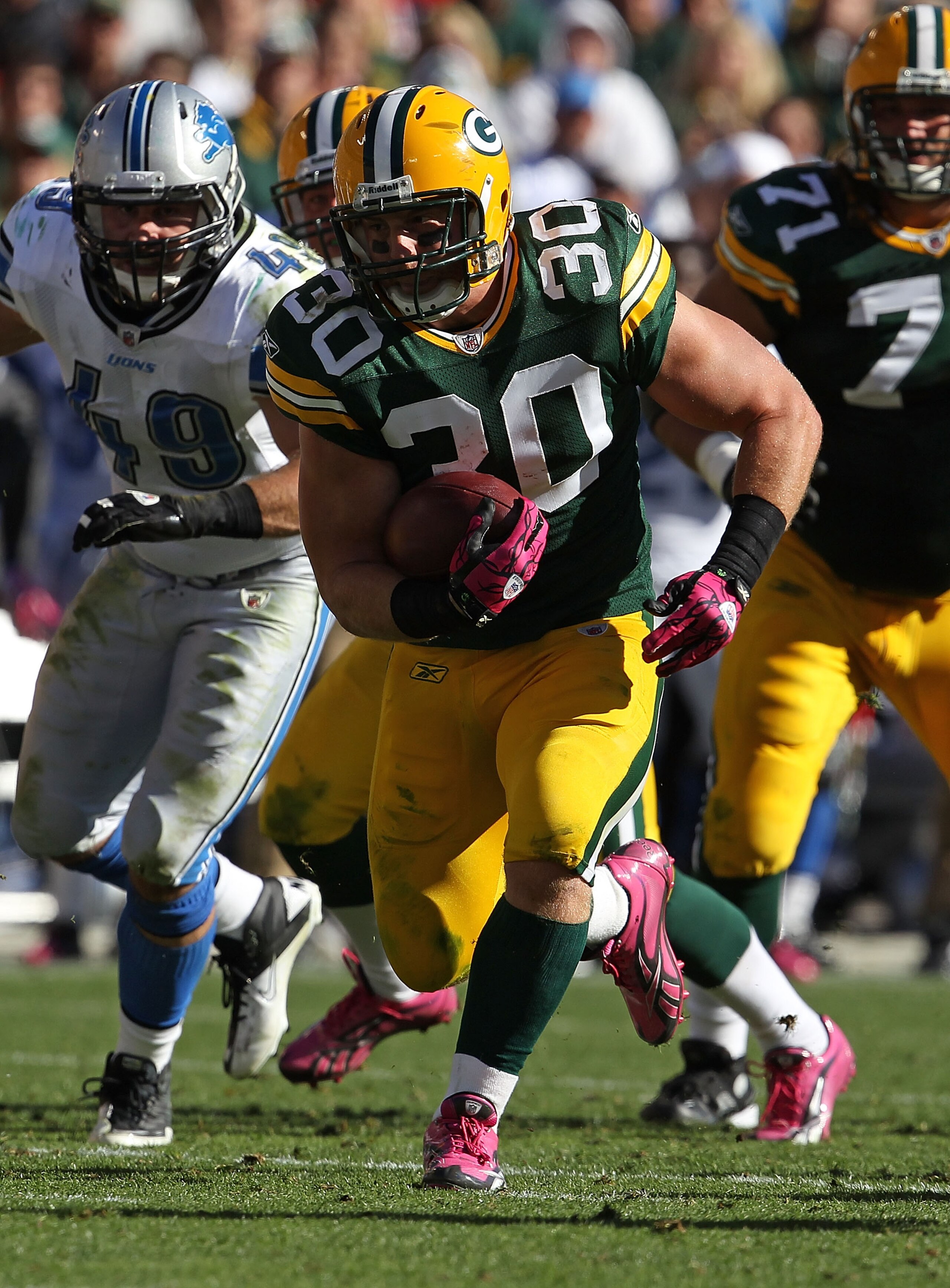 GREEN BAY, WI - OCTOBER 03: John Kuhn #30 of the Green Bay Packers runs against the Detroit Lions at Lambeau Field on October 3, 2010 in Green Bay, Wisconsin. The Packers defeated the Lions 28-26.  (Photo by Jonathan Daniel/Getty Images)