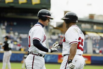 ATLANTA - APRIL 7:  Andruw Jones #25 of the Atlanta Braves congratulates teammate Chipper Jones #10 on hitting a solo home run during the game against the Florida Marlins at Turner Field on April 7, 2003 in Atlanta, Georgia.  The Braves won 3-0.  (Photo b