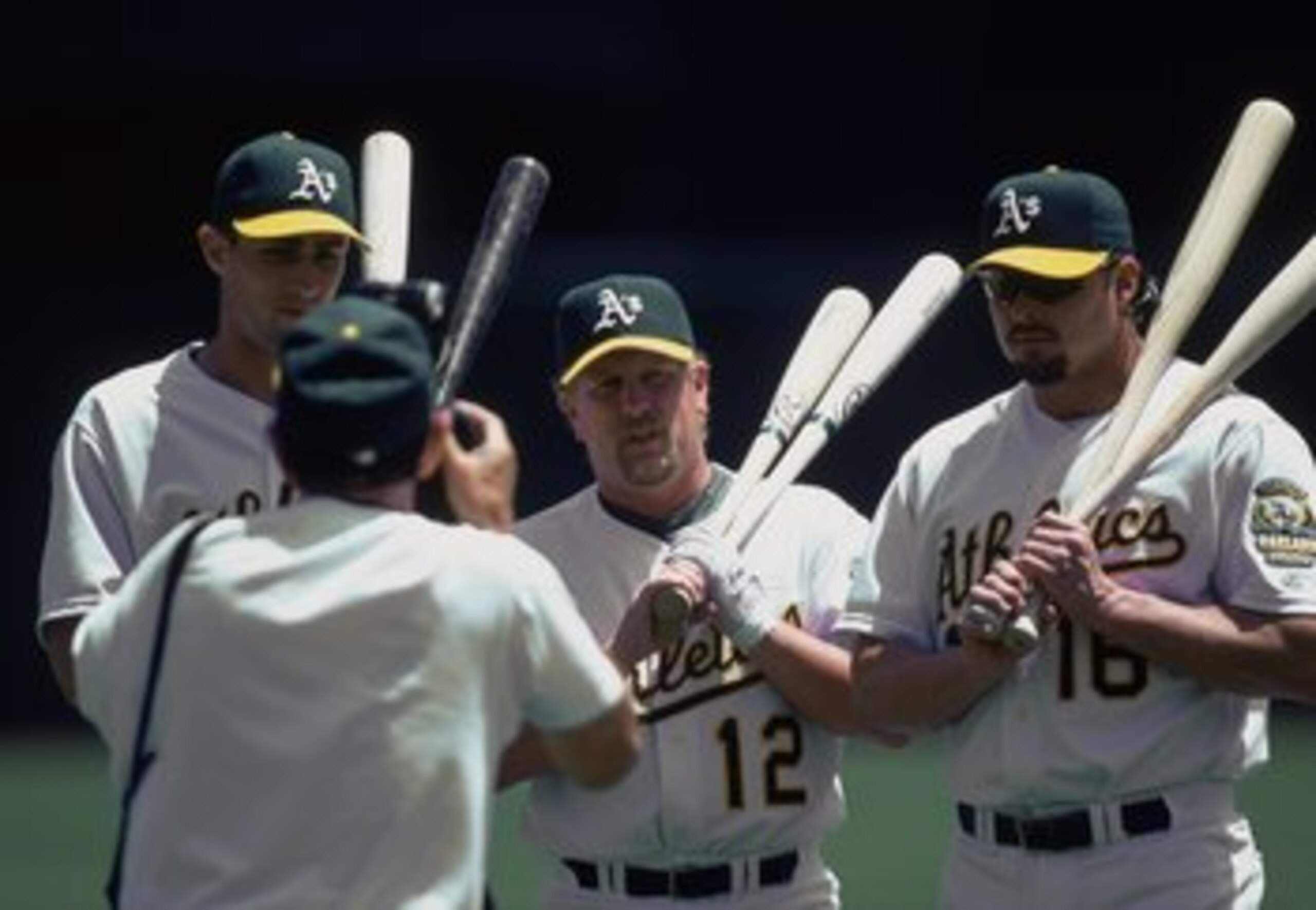 29 Jun 2000:  Jason Giambi, Ben Grieve, and Matt Stairs of Oakland Athletics get their picture taken by A's photographer Michael Zagaris during the game against the Texas Reangers at the Network Associates Coliseum in Oakland, California. The Rangers defe