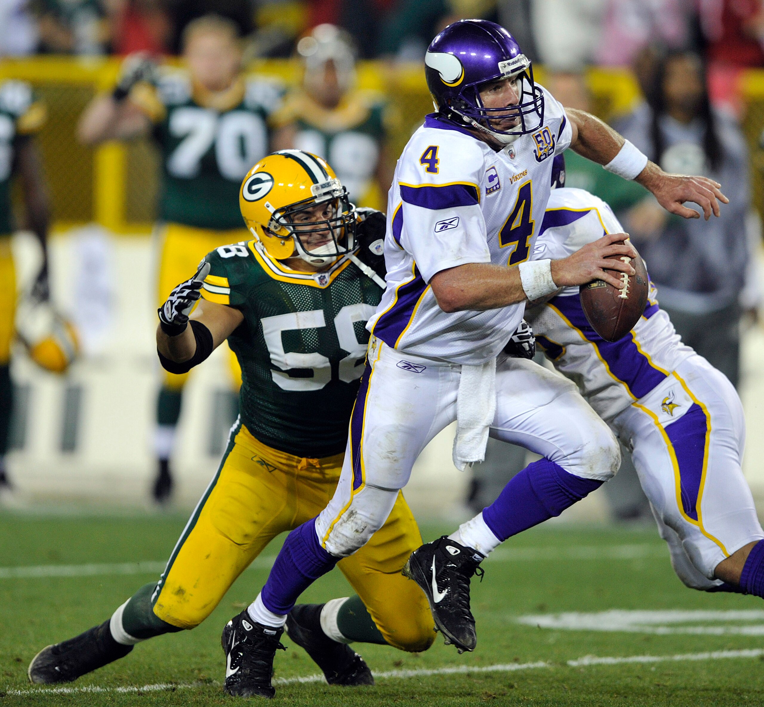 GREEN BAY, WI - OCTOBER 24: Brett Favre #4 of the Minnesota Vikings scrambles away from Frank Zombo #58 of the Green Bay Packers at Lambeau Field on October 24, 2010 in Green Bay, Wisconsin. The Packers defeated the Vikings 28-24. (Photo by Jim Prischin GREEN BAY, WI - OCTOBER 24: Brett Favre #4 of the Minnesota Vikings scrambles away from Frank Zombo #58 of the Green Bay Packers at Lambeau Field on October 24, 2010 in Green Bay, Wisconsin. The Packers defeated the Vikings 28-24. (Photo by Jim Prischin