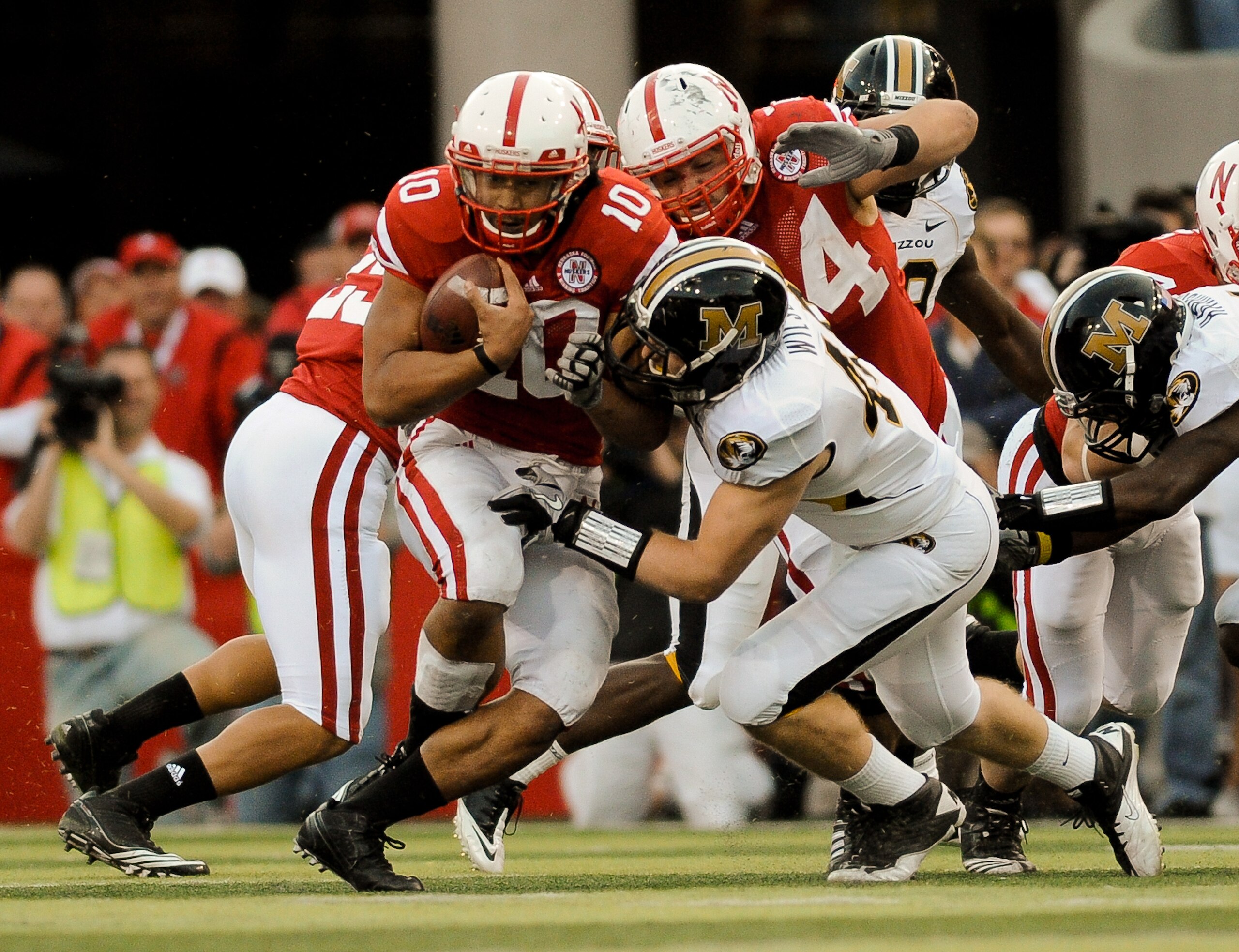 LINCOLN, NE - OCTOBER 30: Running back Roy Helu Jr. #10 of the Nebraska Cornhuskers slipped through the grasp of Andrew Wilson #48 Missouri Tigers Defense during second half action of their game at Memorial Stadium on October 30, 2010 in Lincoln, Nebraska